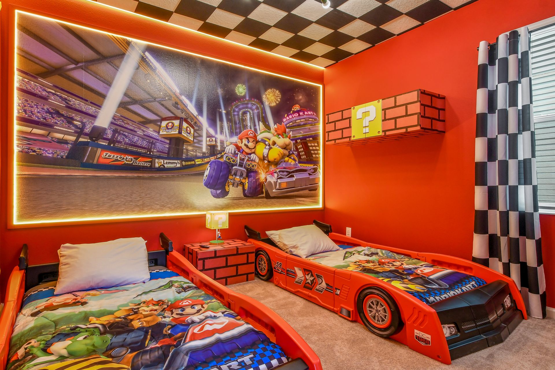 Mario-themed kids' room with race car beds, vibrant decor, and playful gaming details.
