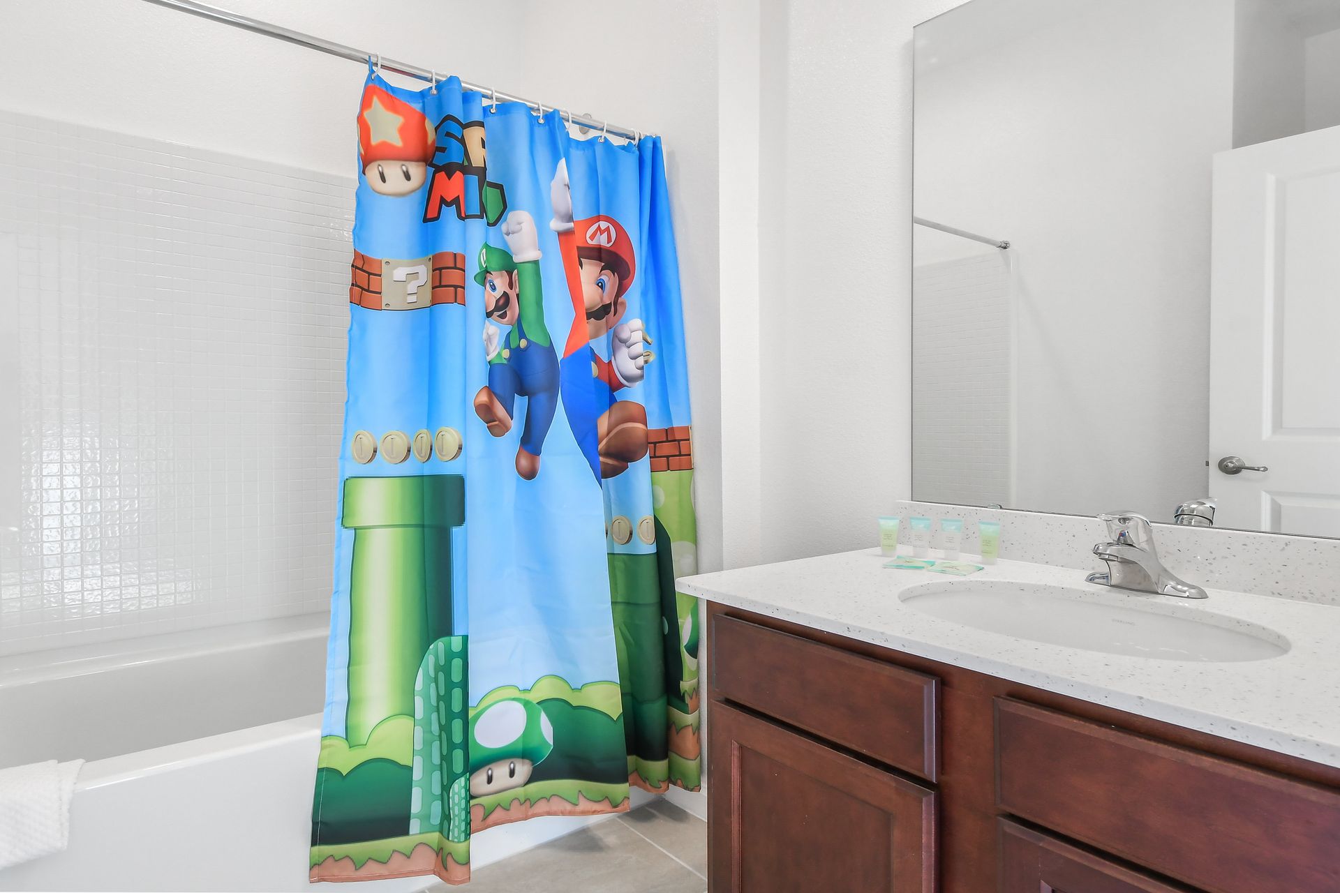Fun bathroom with a vibrant Mario-themed shower curtain, perfect for kids and gamers!
