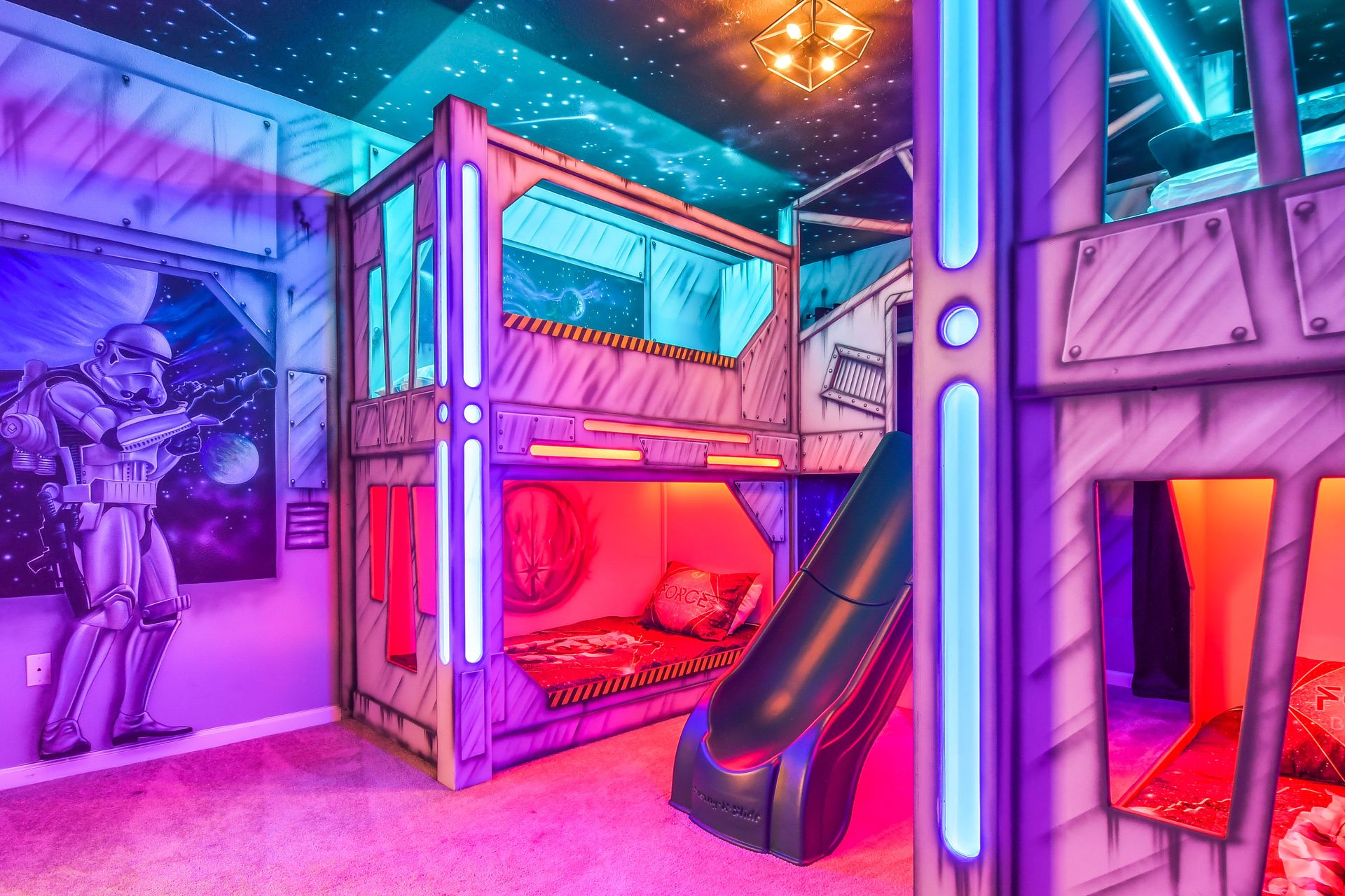 Bunk beds with a slide in a Star Wars themed room.