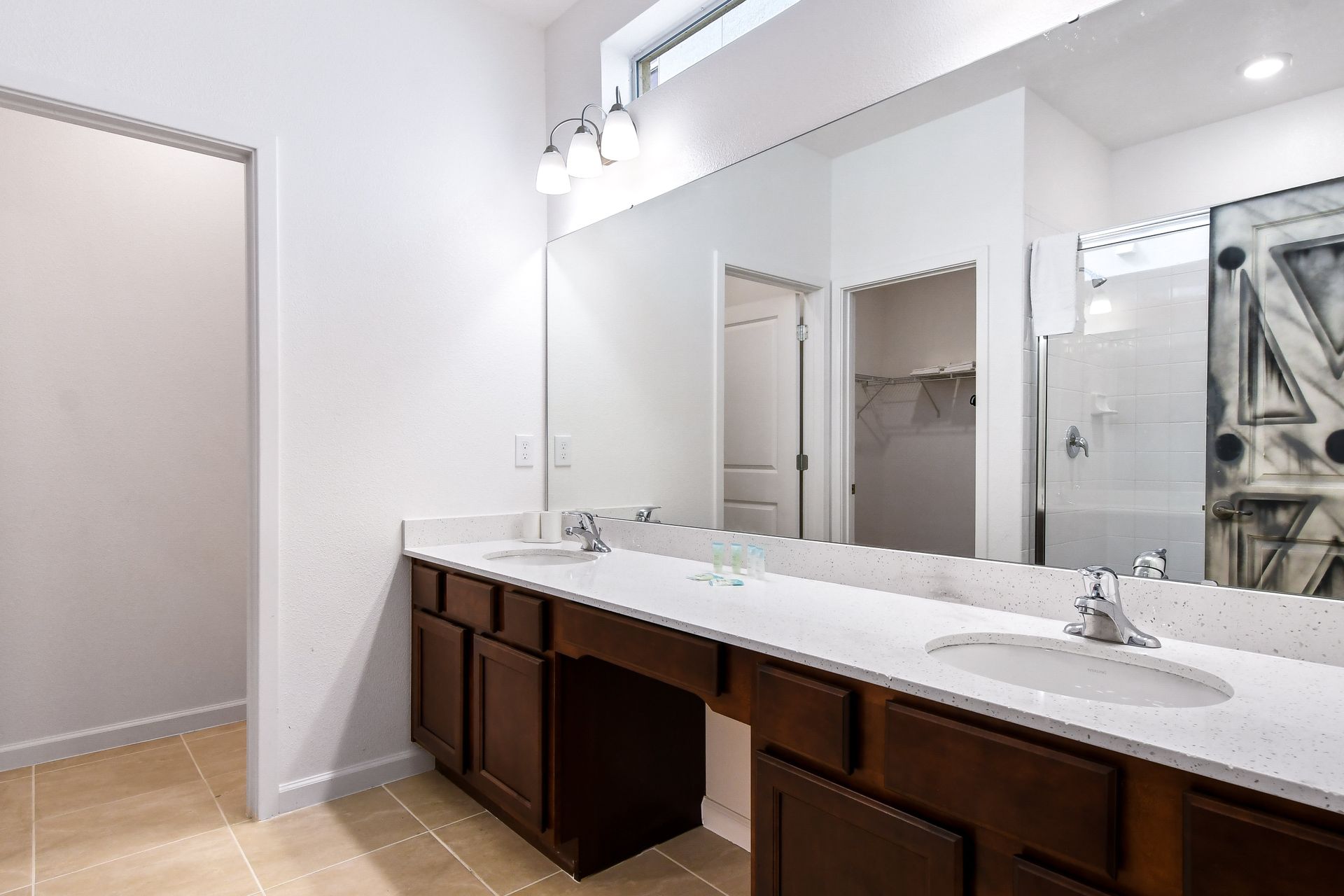 Spacious bathroom with a double vanity, modern fixtures, and a walk-in shower design.