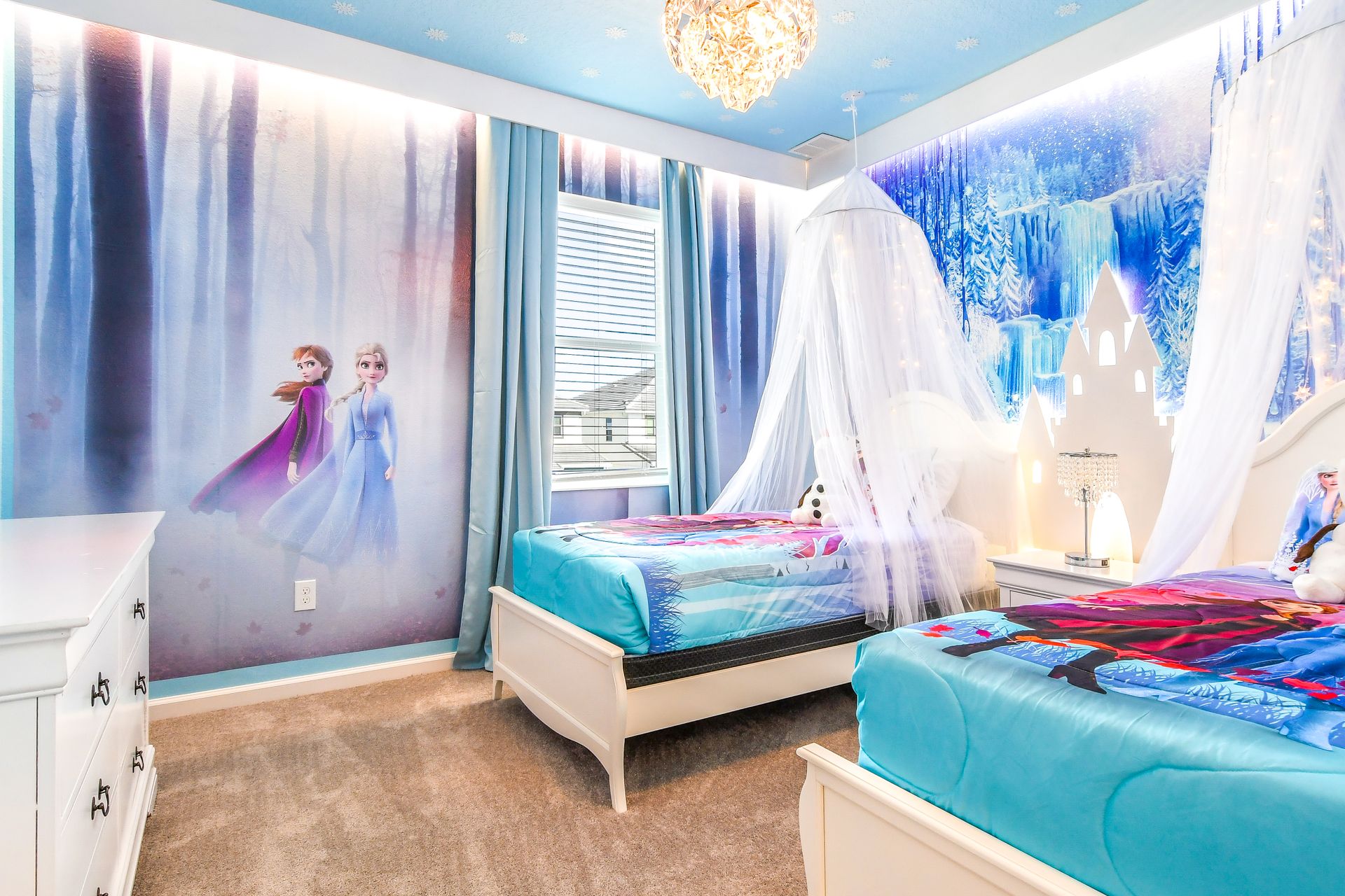 Elegant two single beds and a Frozen themed wall, fit for royalty