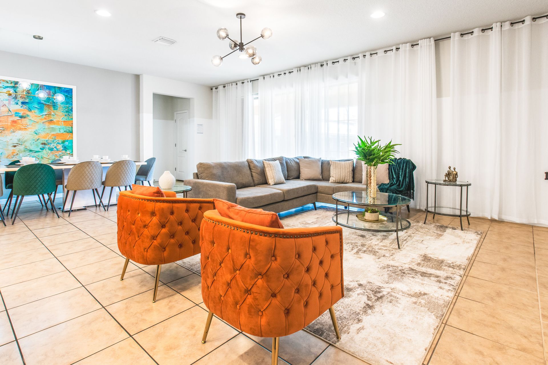 Modern living area with a sleek TV setup, elegant decor, and cozy seating!