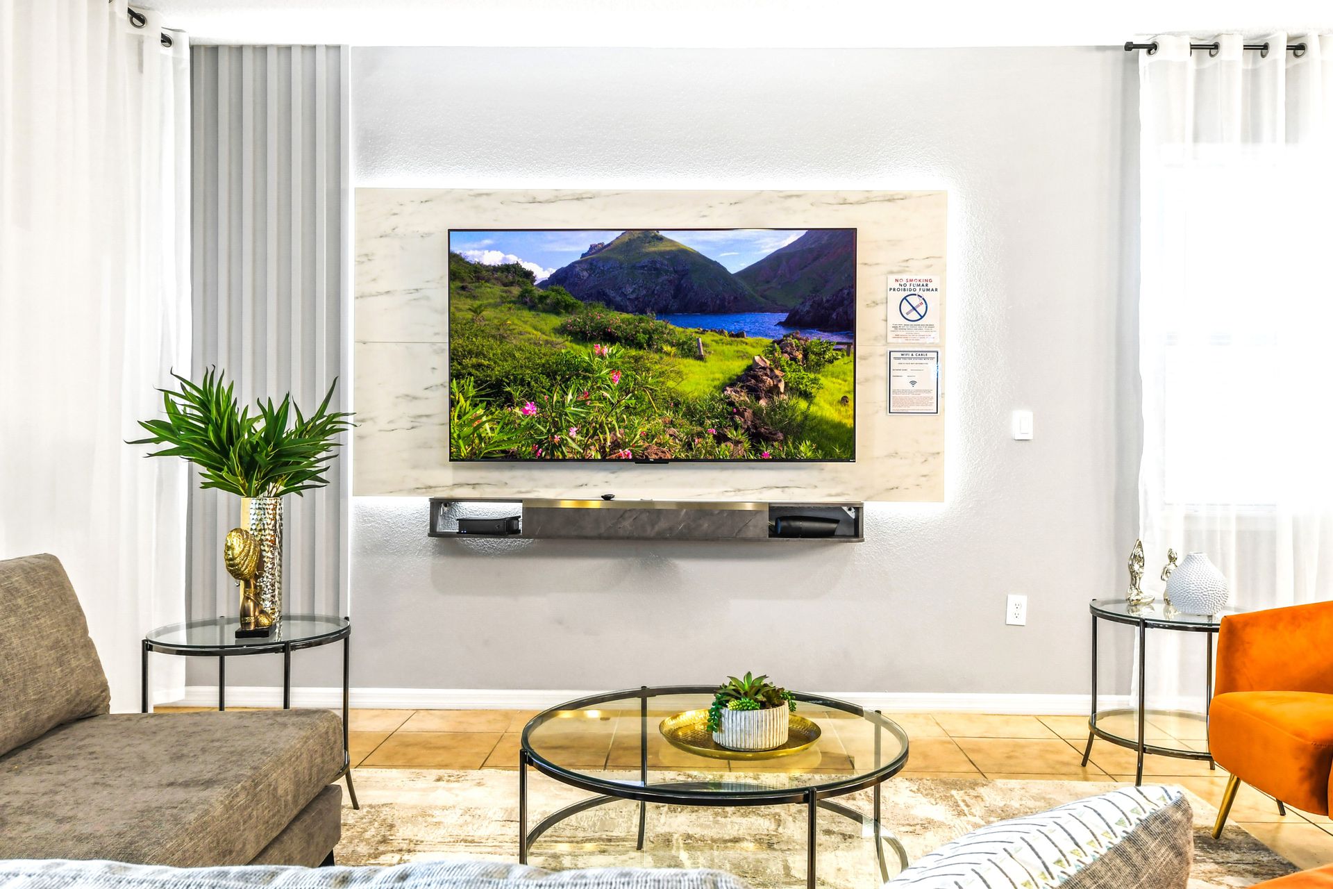 Modern living area with a sleek TV setup, elegant decor, and cozy seating!
