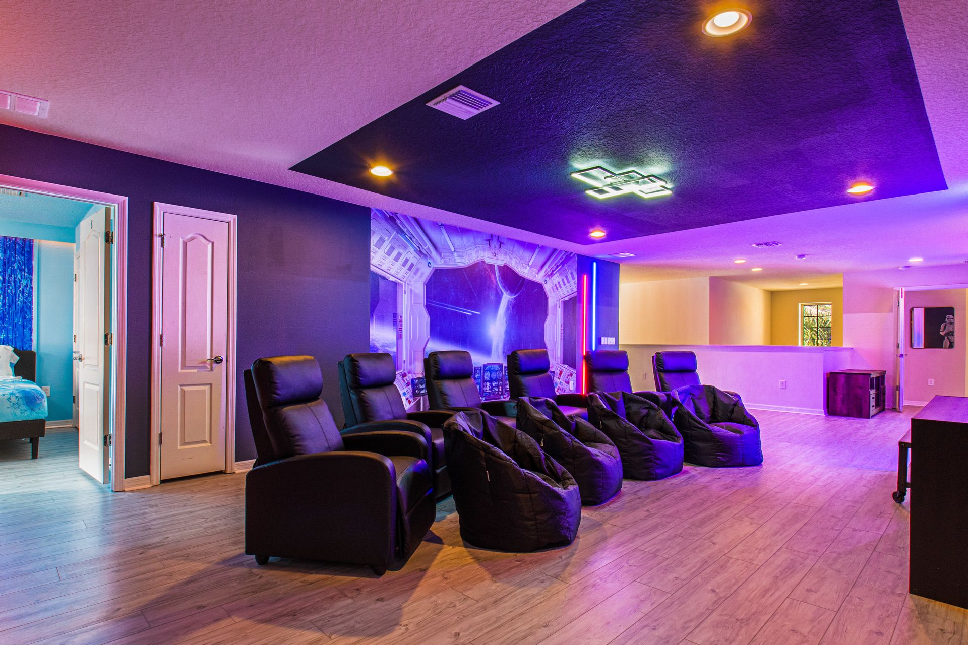 Futuristic Star Wars-themed theater with cozy seating, neon lights, and epic vibes!