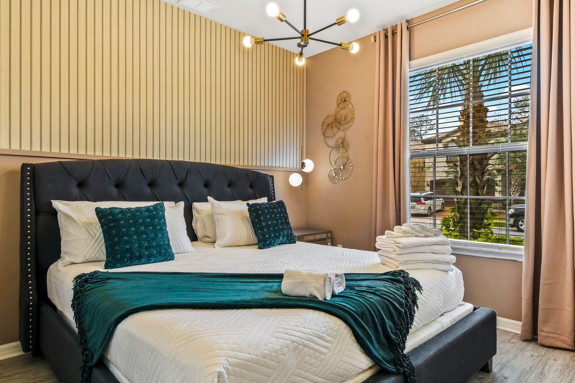 Elegant bedroom with a plush king bed, modern lighting, and a warm, inviting vibe!