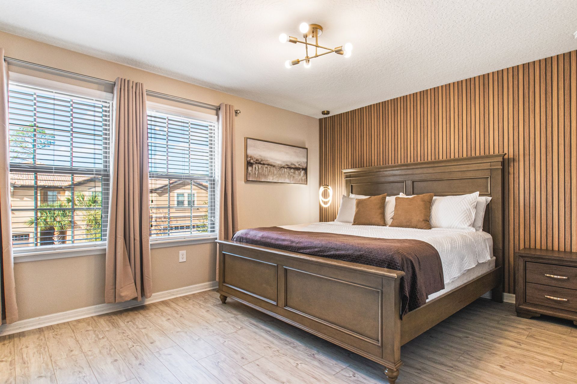 Elegant bedroom with warm wood accents, modern lighting, and a cozy king-size bed!