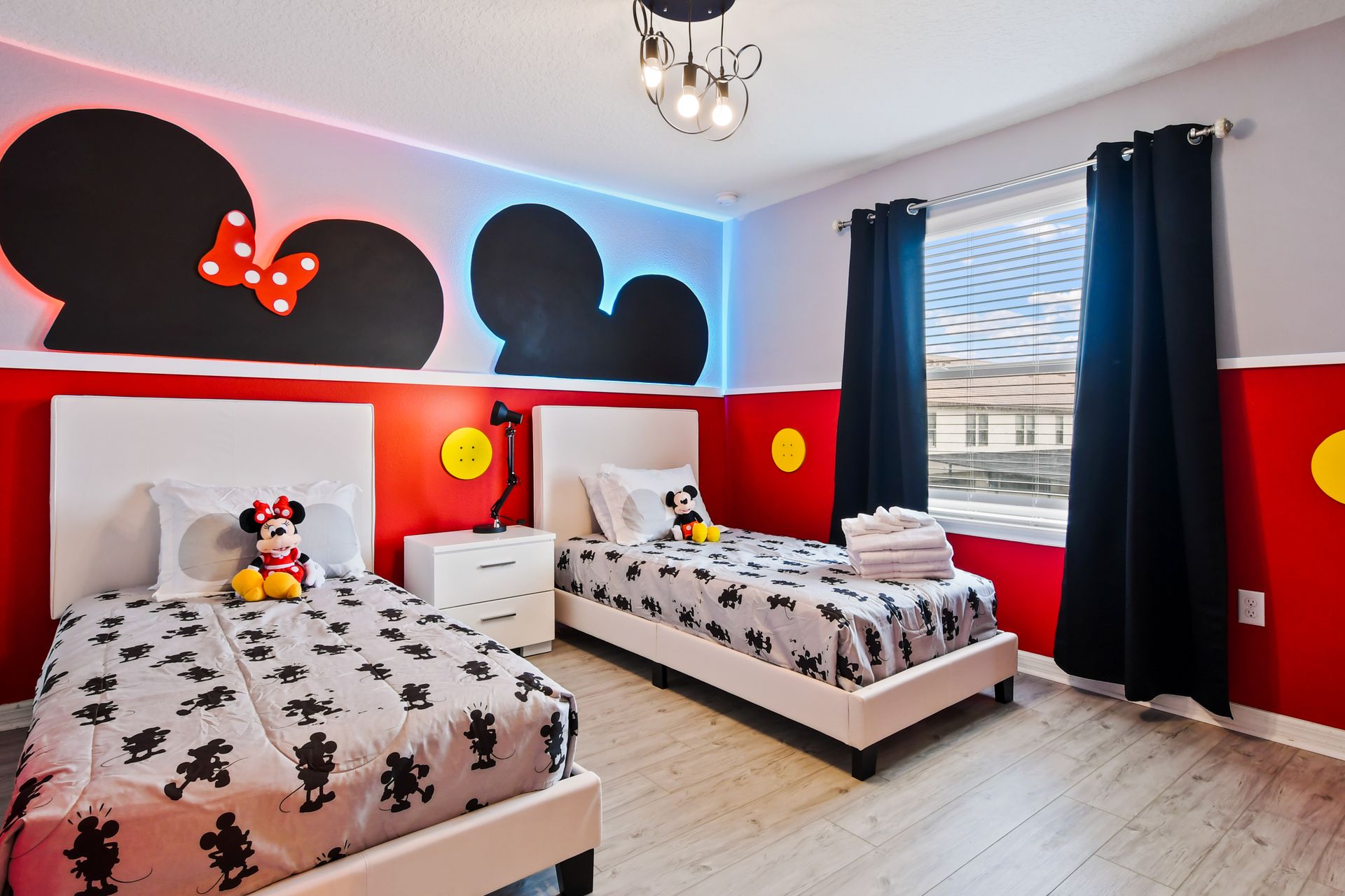 Magical Mickey & Minnie-themed bedroom with twin beds, fun decor, and cozy vibes!