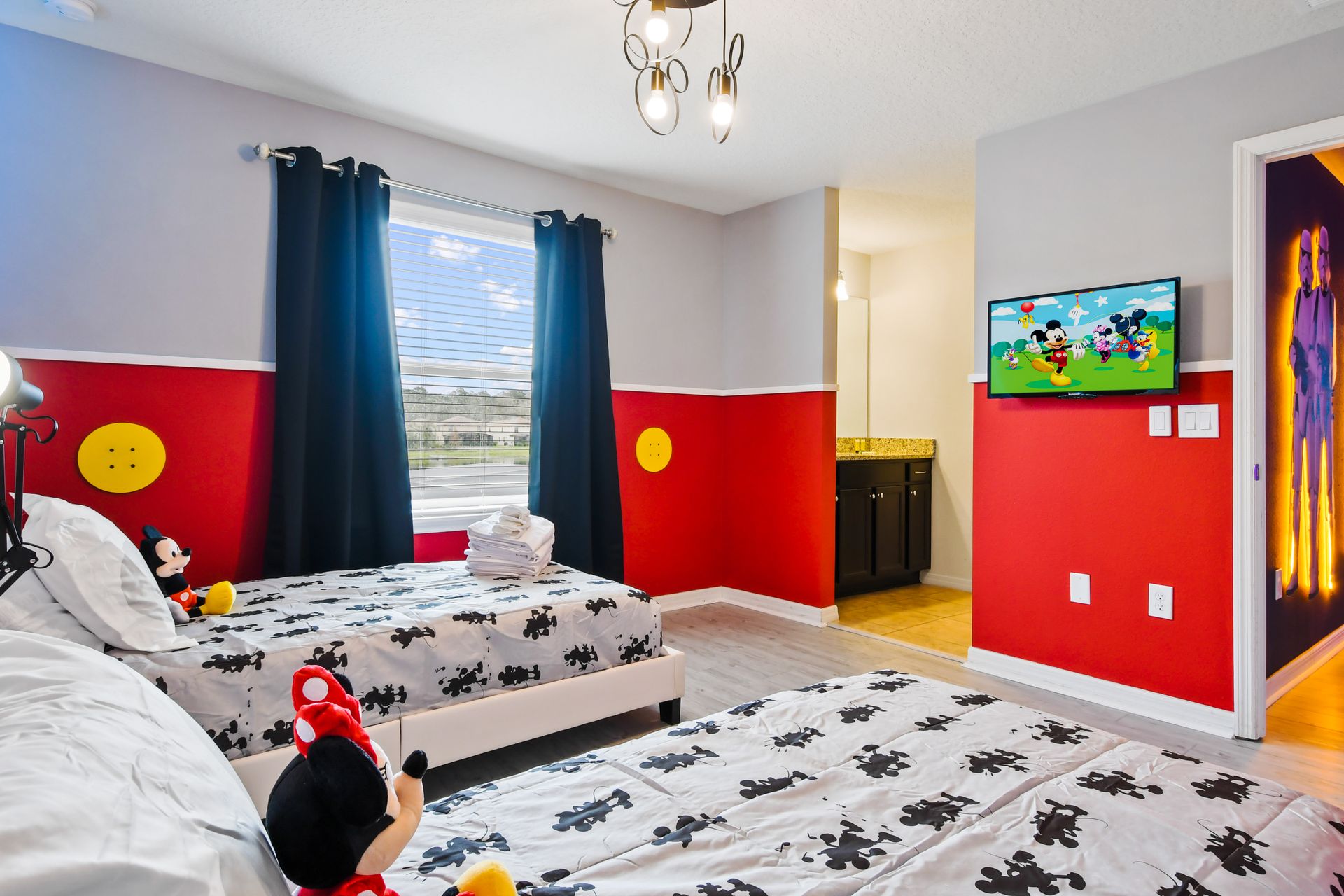Magical Mickey & Minnie-themed bedroom with twin beds, fun decor, and cozy vibes!