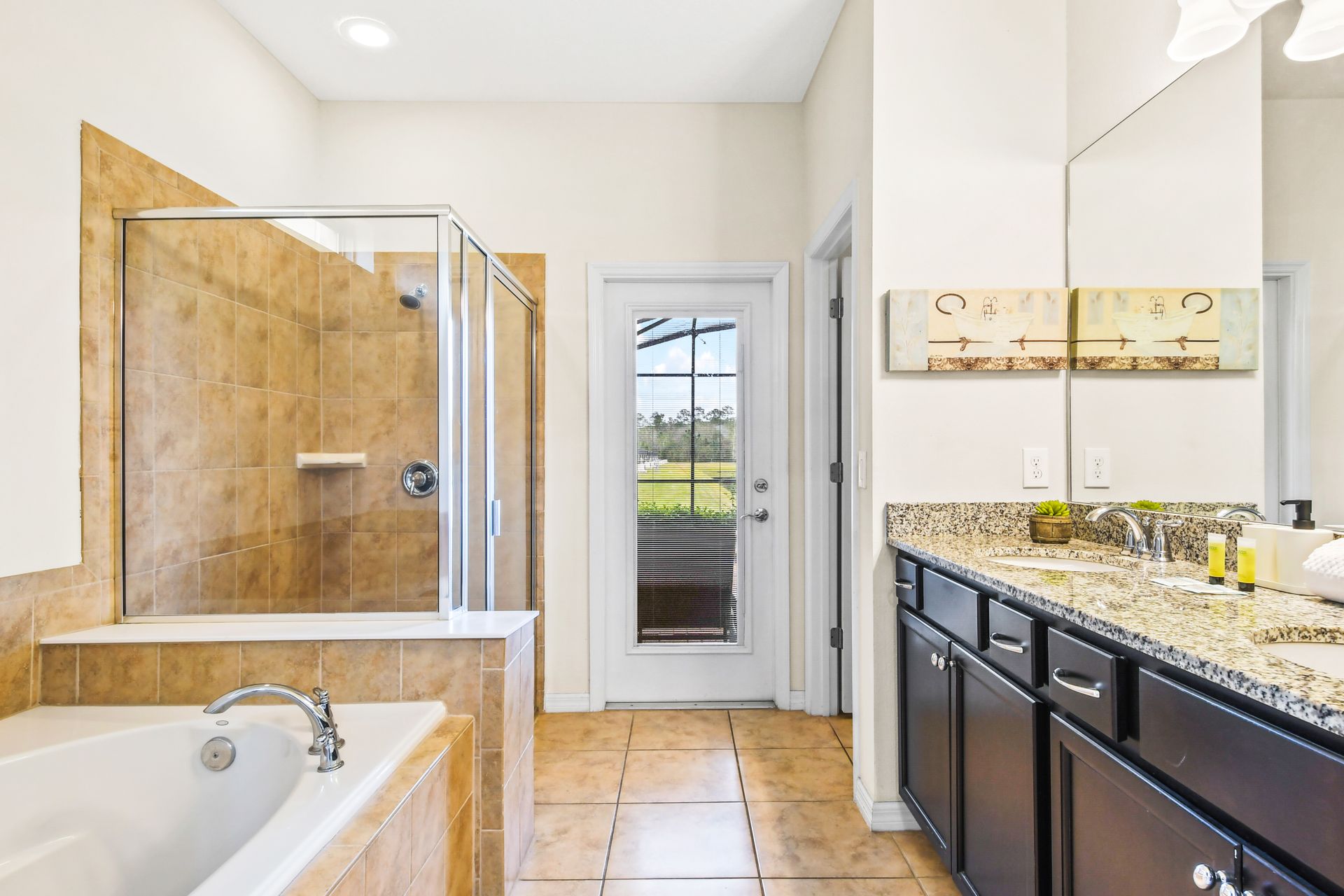 Spacious bathroom with a soaking tub, walk-in shower, and poolside access!
