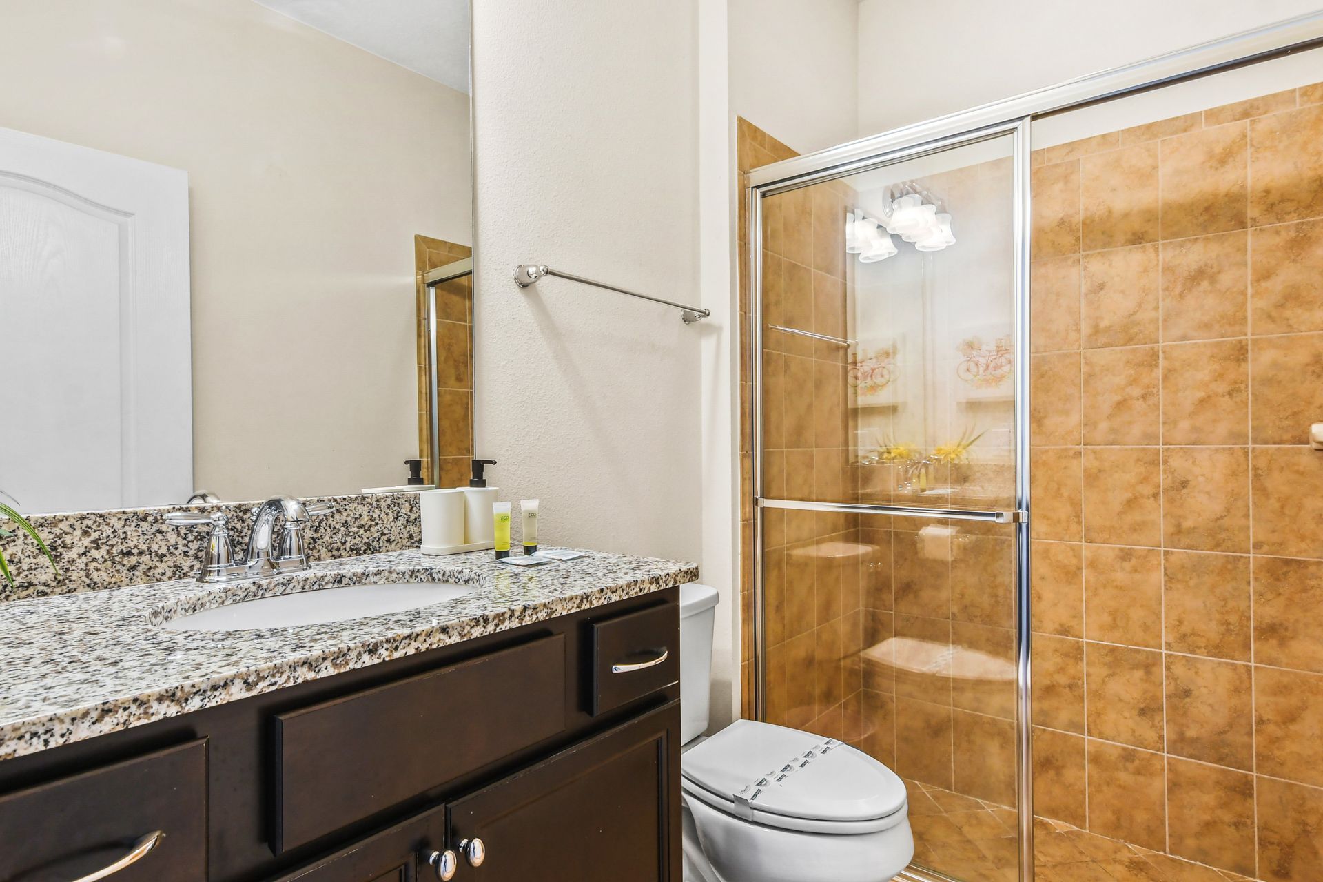 Stylish bathroom with a granite vanity, glass-enclosed shower, and modern finishes!