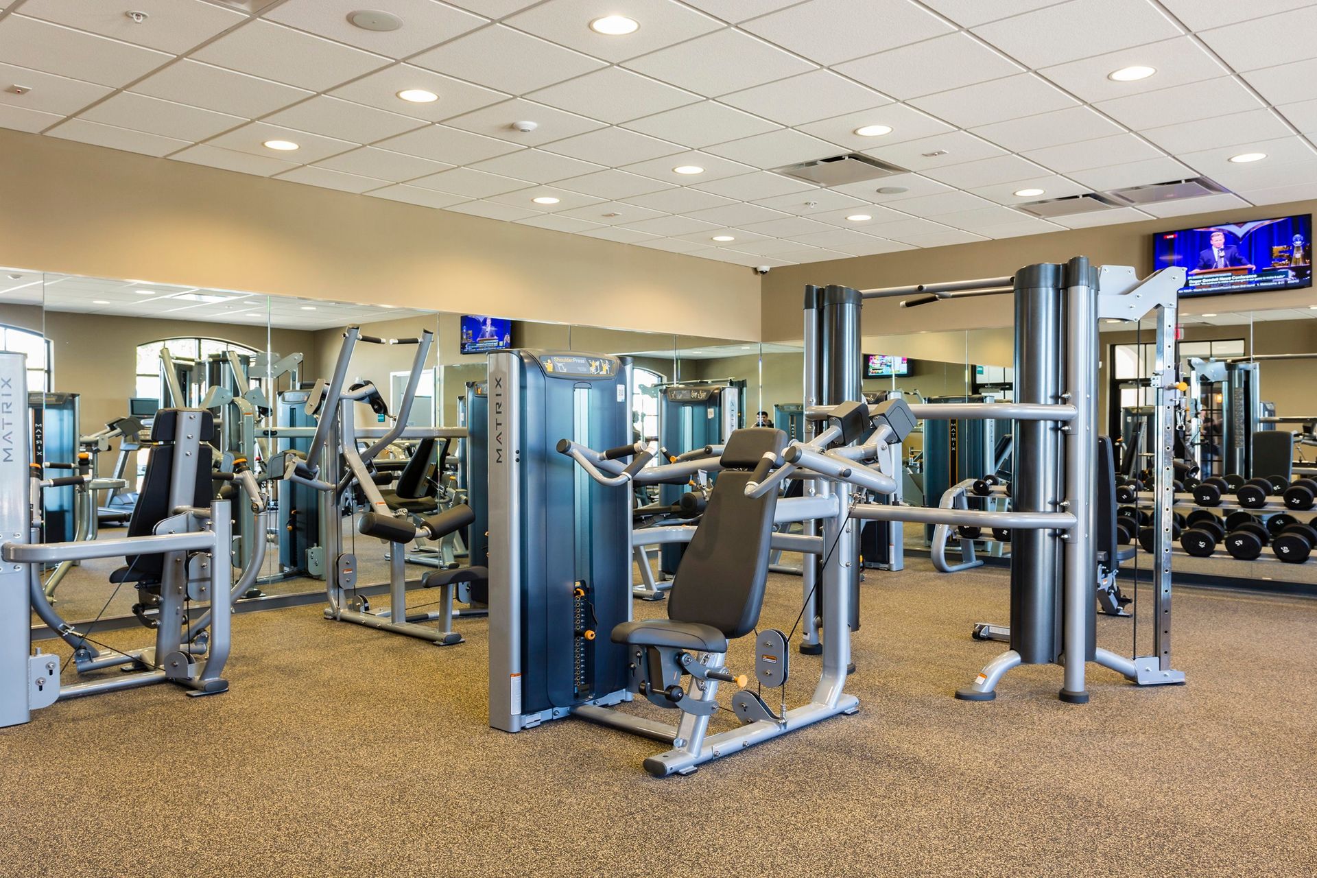 Fully equipped fitness center with weight machines, cardio gear, and TVs to keep you motivated!