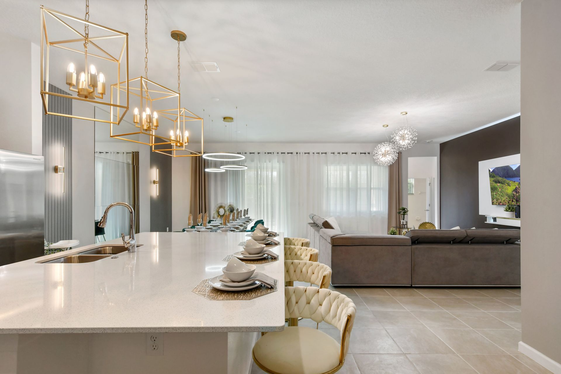 Bright, modern kitchen with island seating, elegant décor, and open living flow.
