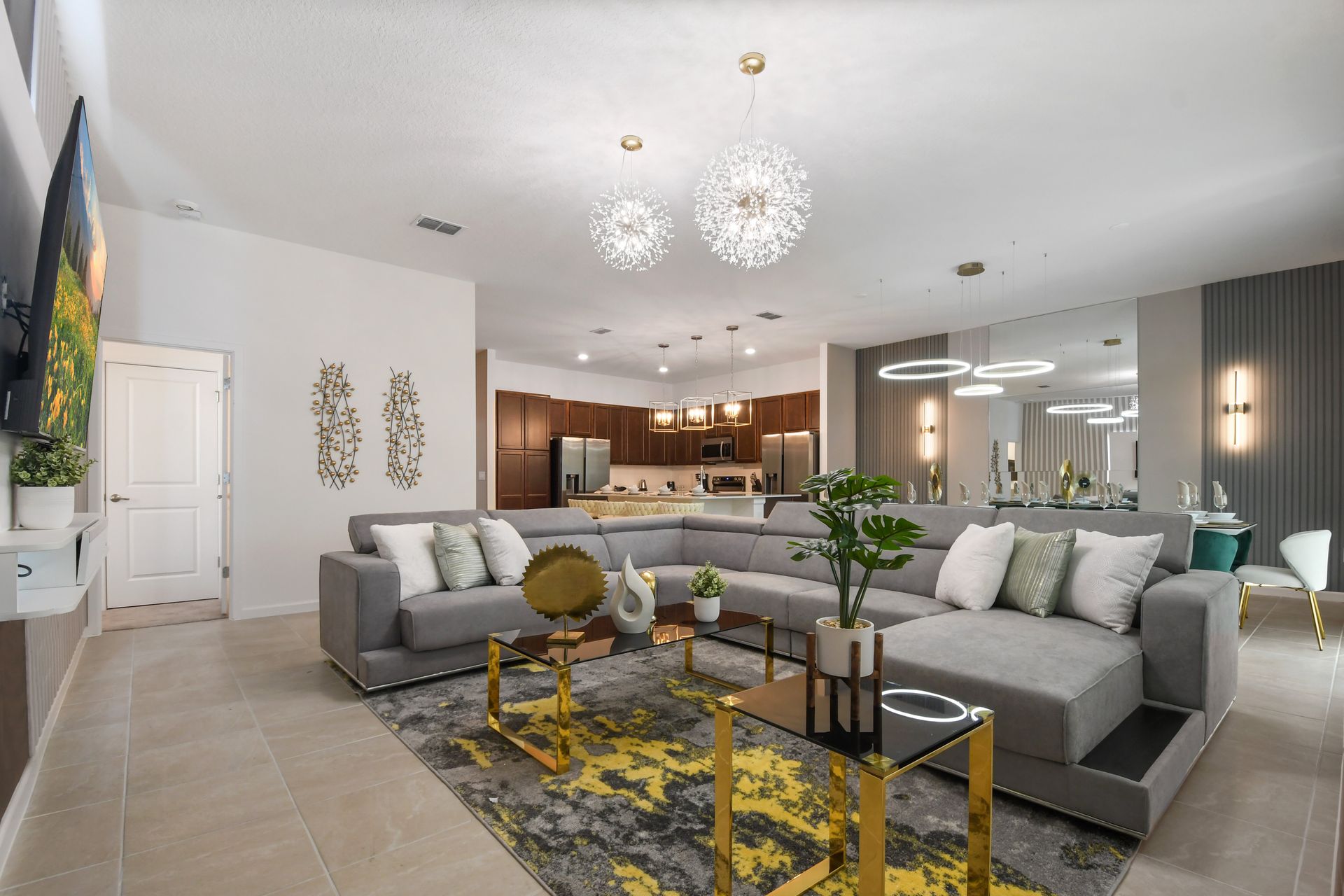 Open-concept luxury with sleek kitchen, plush seating, and designer lighting.
