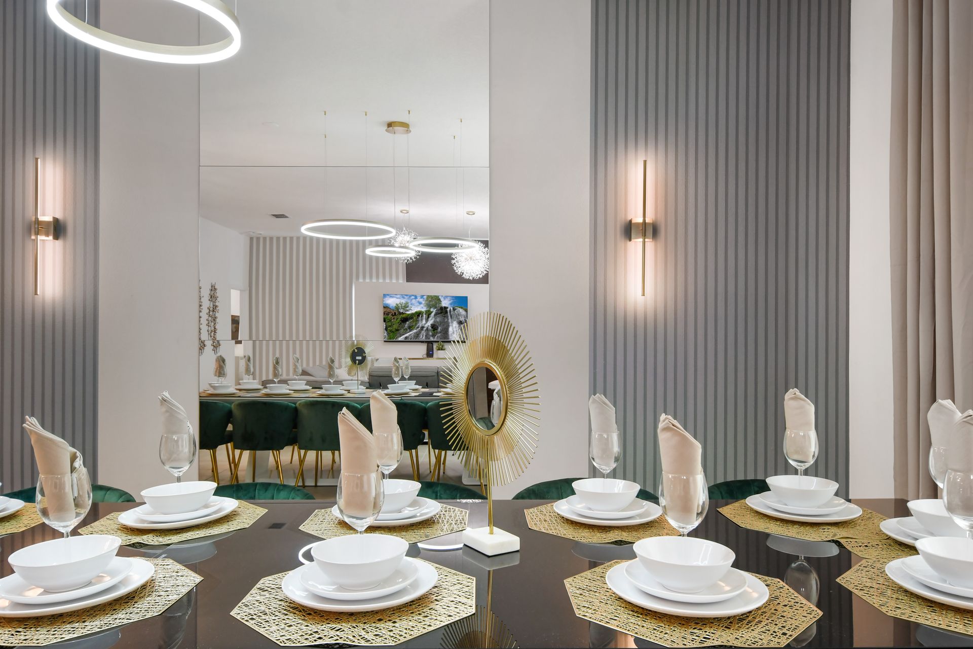 Elegant dining setup with modern lighting, gold accents, and mirrored flair.
