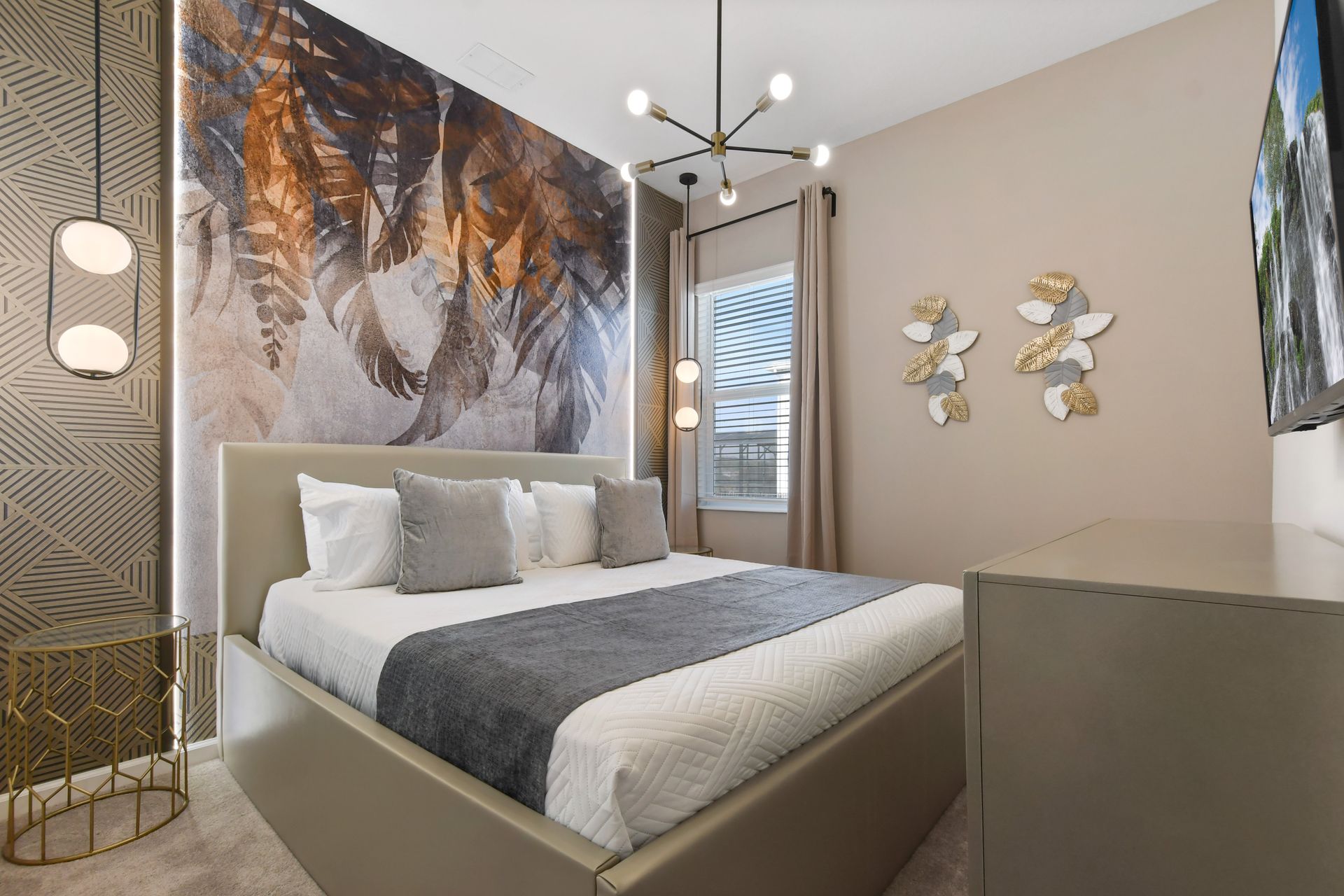 Bold accent wall, cozy king bed, and chic lighting create a stylish escape.
