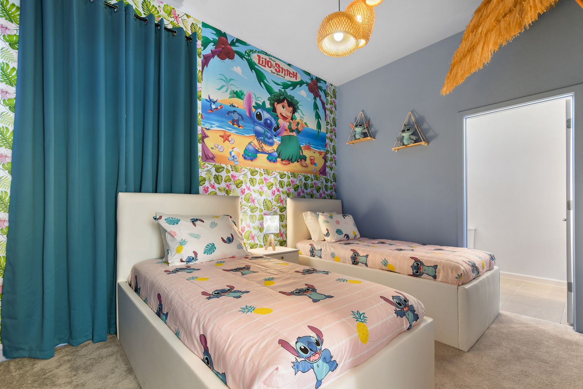 Tropical-themed kids’ room with twin beds, playful decor, and island vibes.
