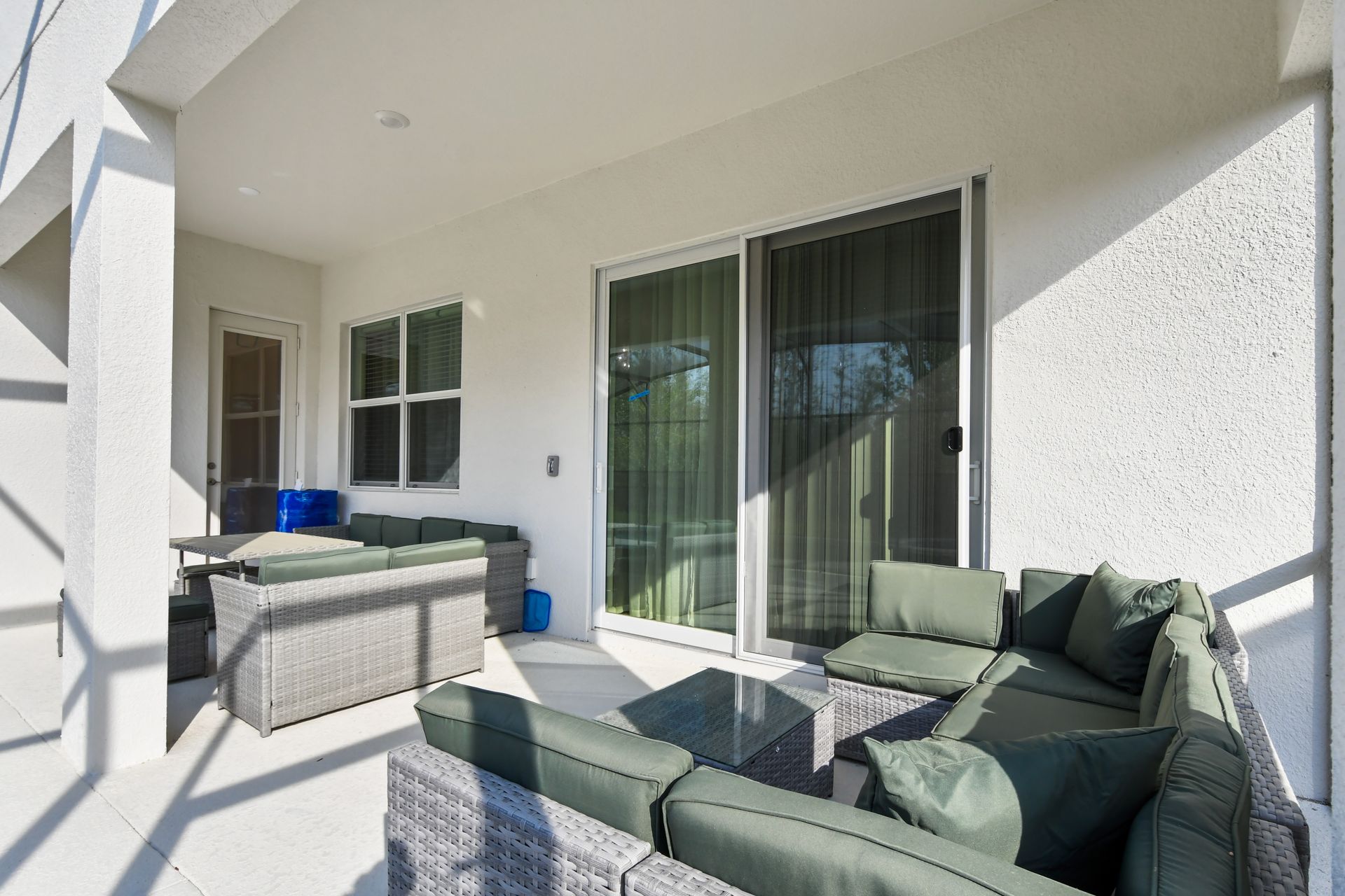 Spacious screened patio with dining, lounge seating, and private pool view.
