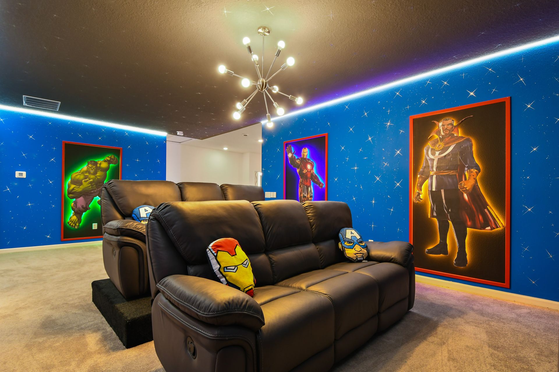 Hero-themed home theater with cozy recliners, starry walls, and epic style.
