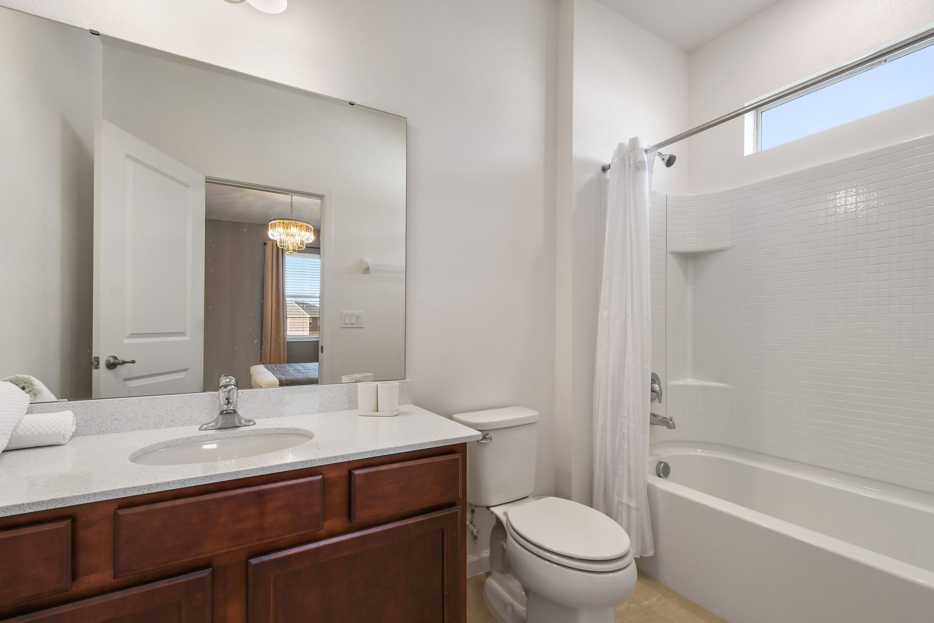 Clean and modern bathroom with bright lighting, full tub, and elegant finishes.
