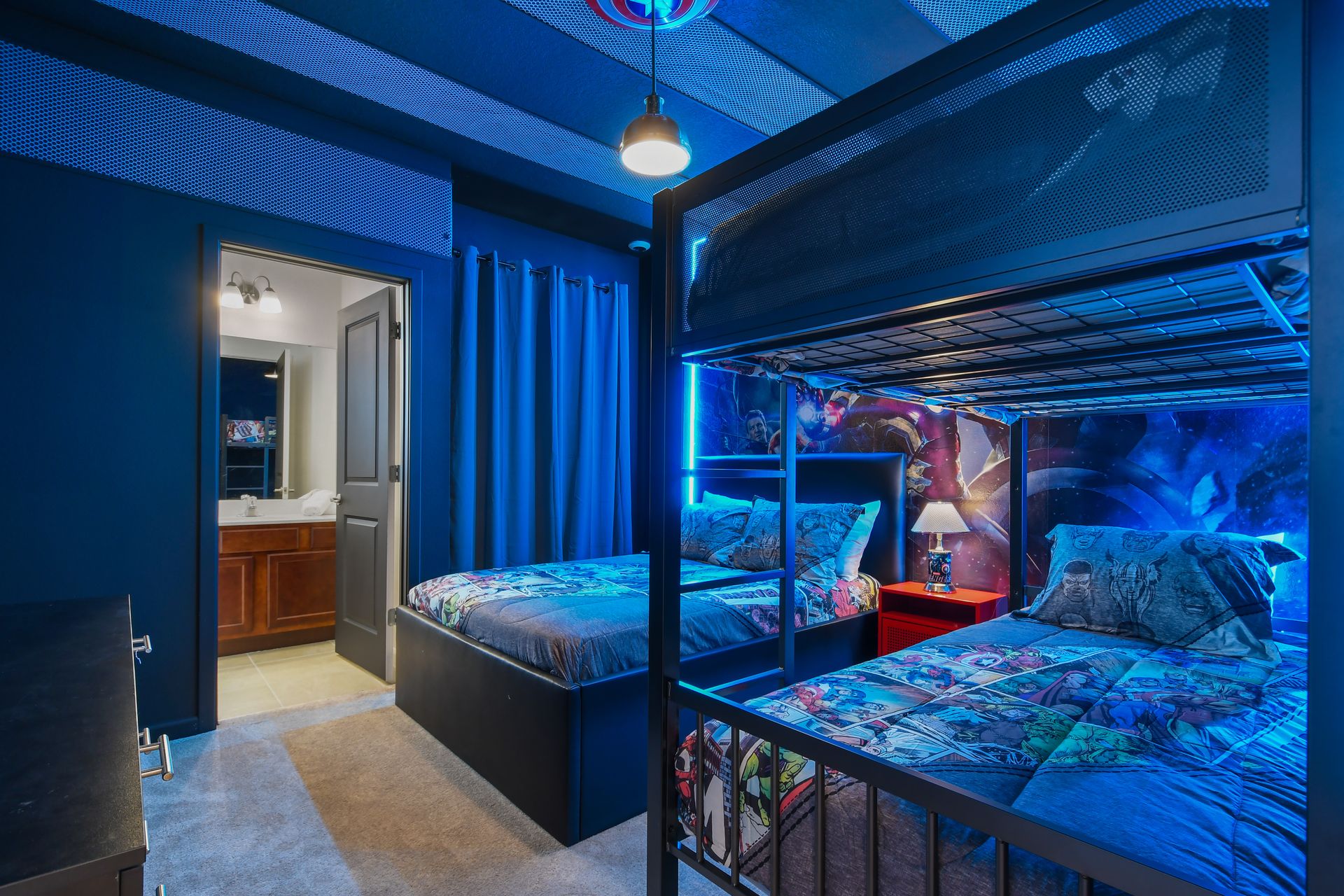 Action-packed bunk room with hero-themed décor, glowing lights, and twin beds.
