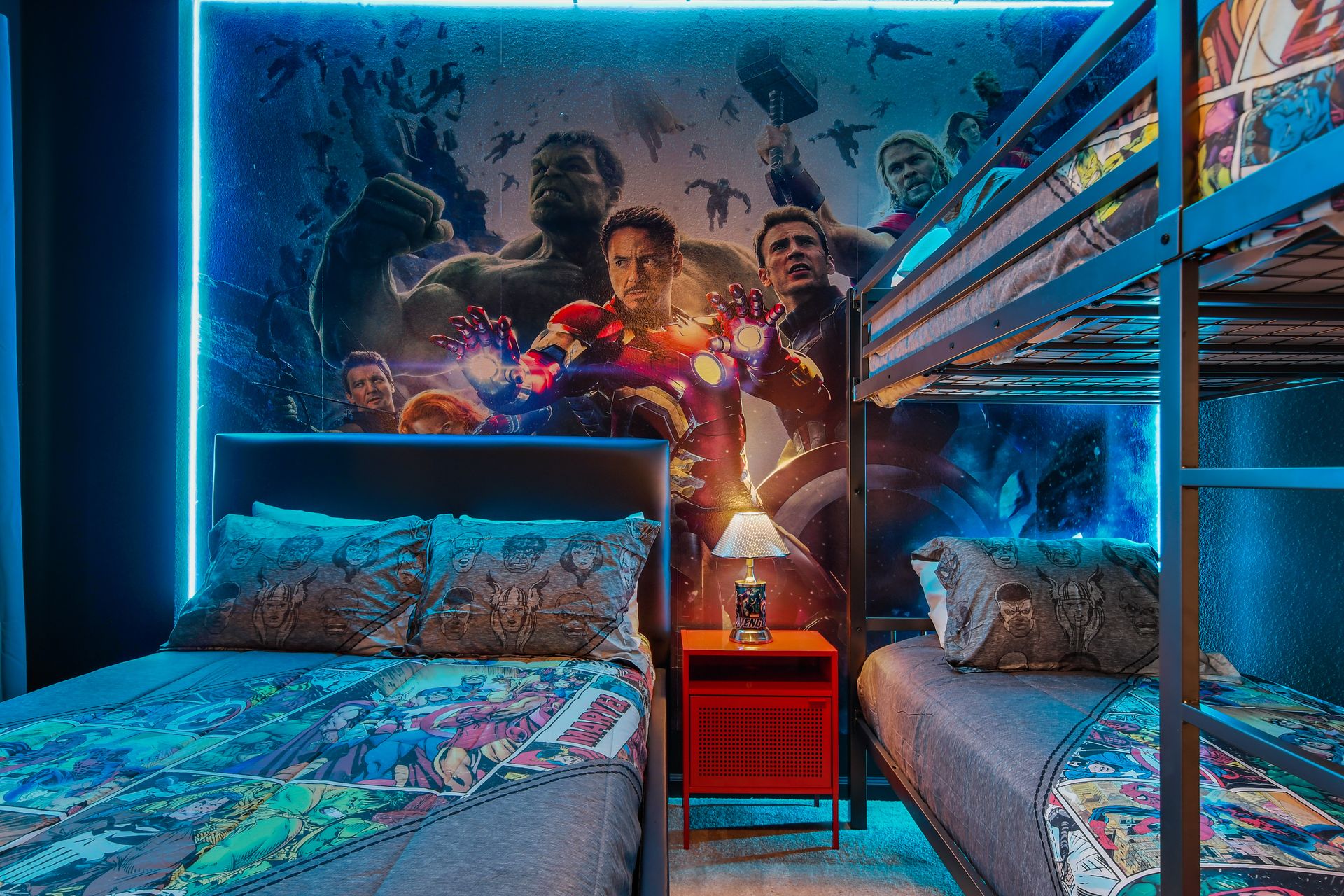 Action-packed bunk room with hero-themed décor, glowing lights, and twin beds.
