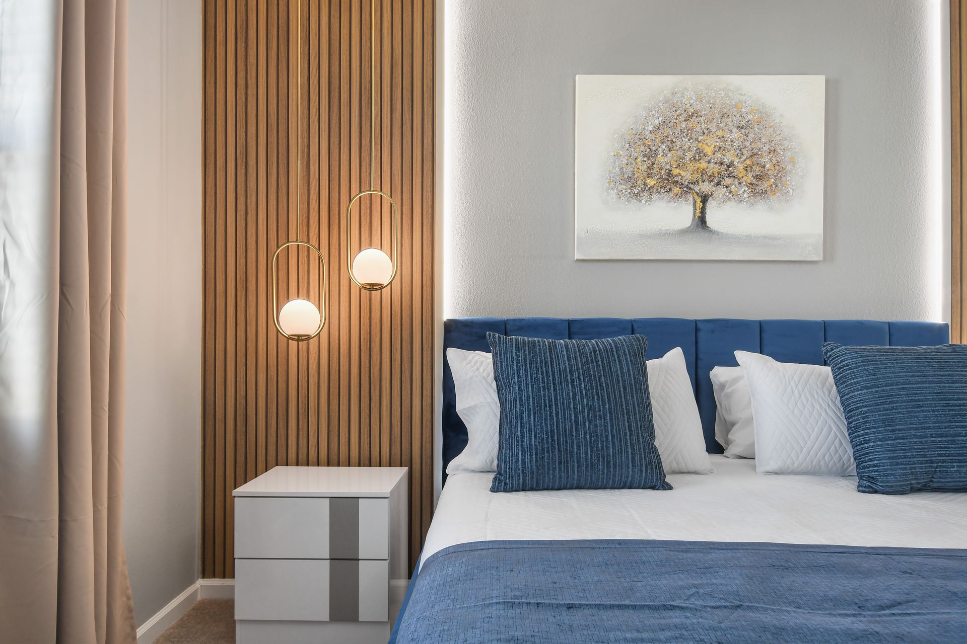 Modern comfort with a cozy king bed, warm wood accents, and soft lighting.
