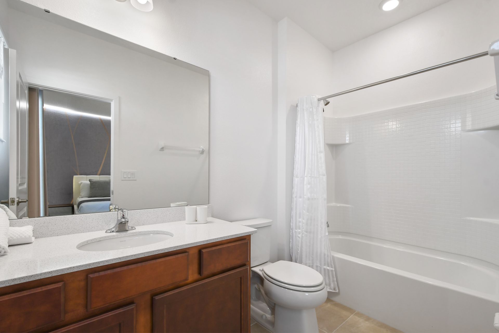 Clean and modern bathroom with bright lighting, full tub, and elegant finishes.
