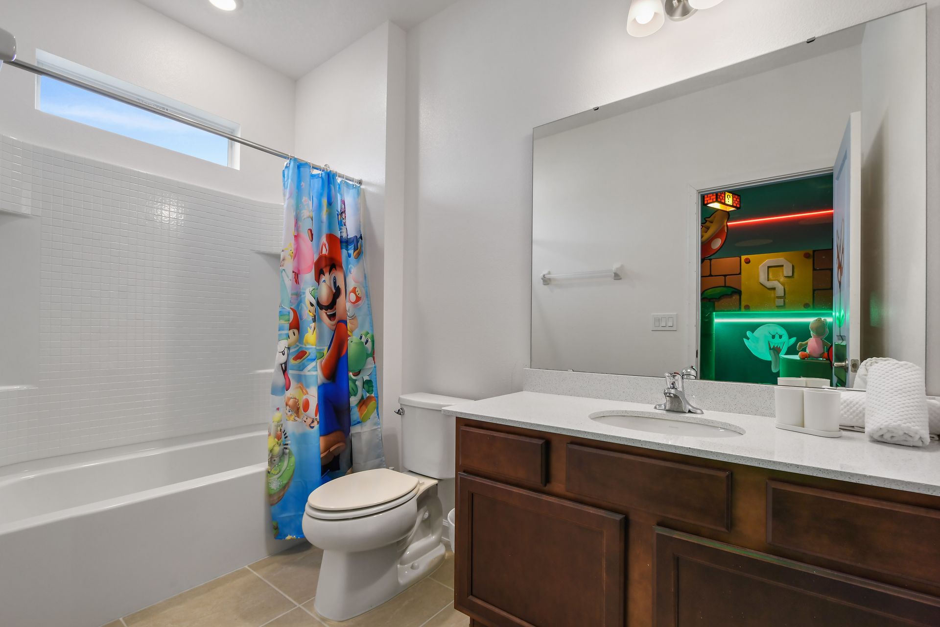 Fun and bright Mario-themed bathroom with full tub and family-friendly touches.
