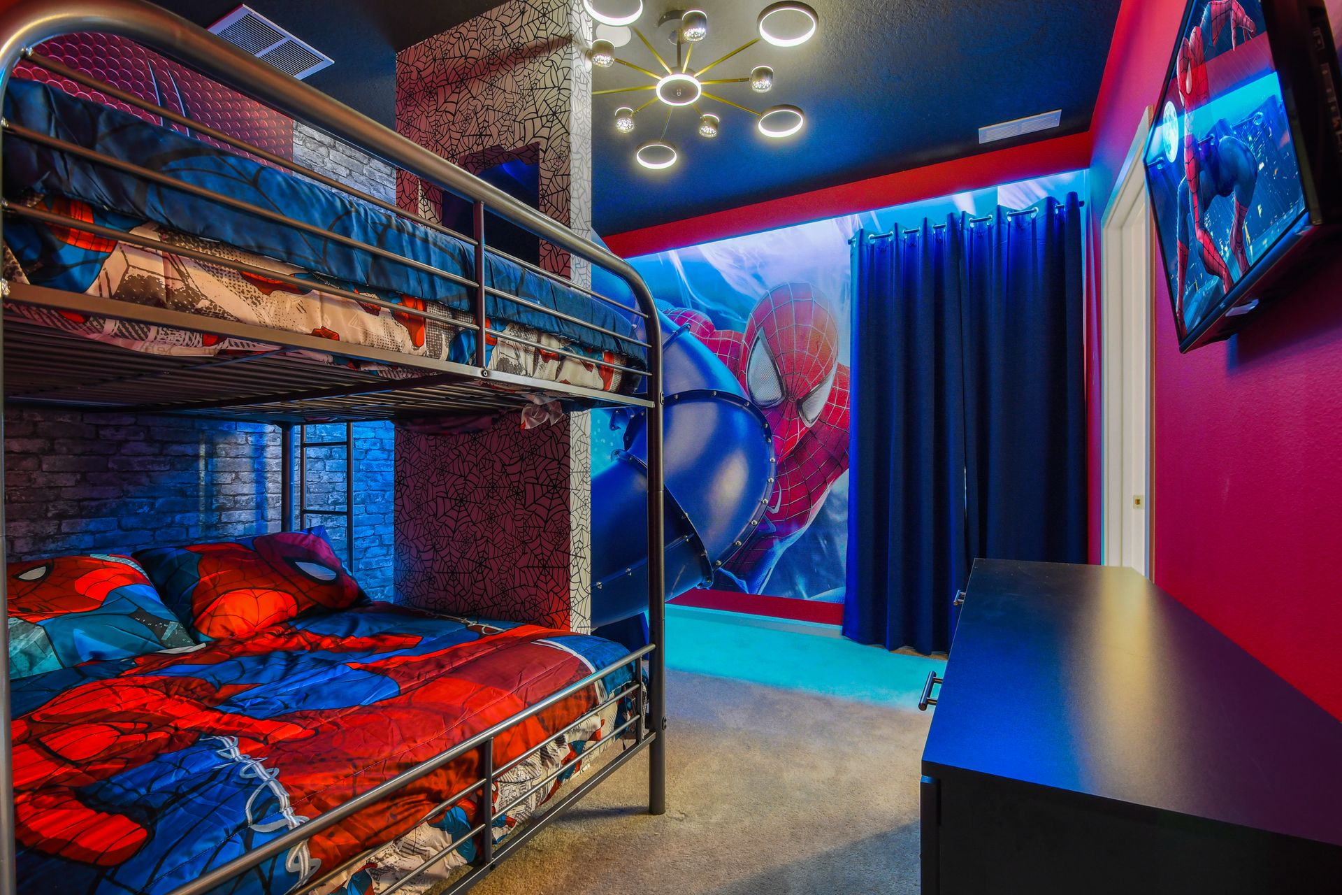Web-slinging adventure room with themed bunk beds, slide, and superhero style.
