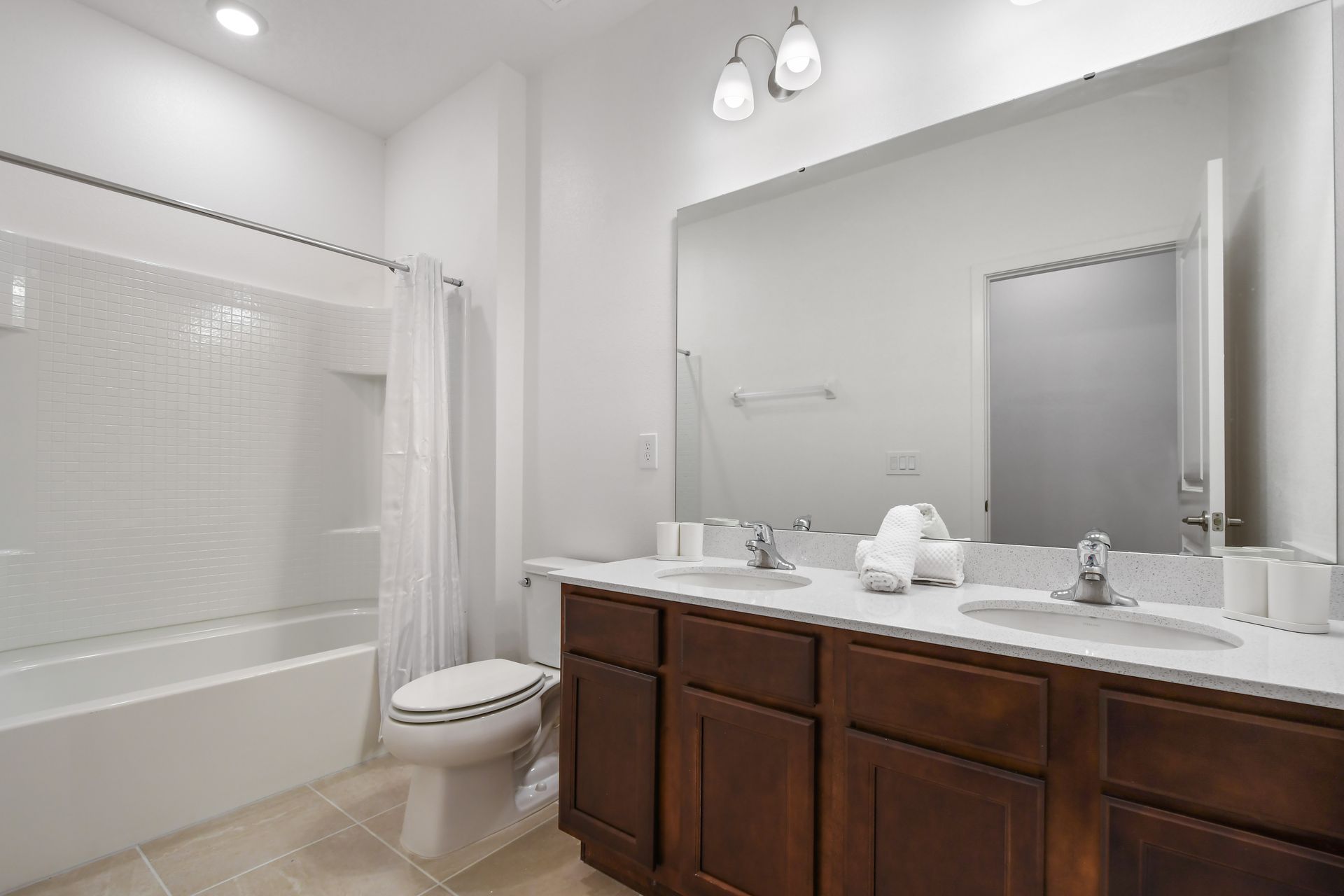 Clean and modern bathroom with bright lighting, full tub, and elegant finishes.
