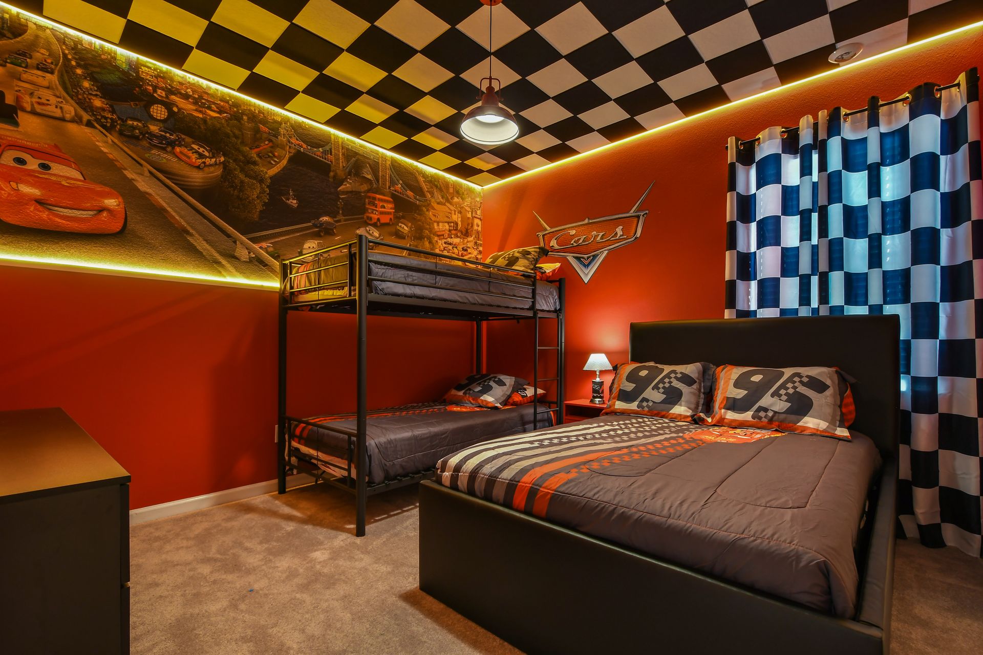 Race into fun with this Cars-themed room featuring bunks, bold colors, and flair.
