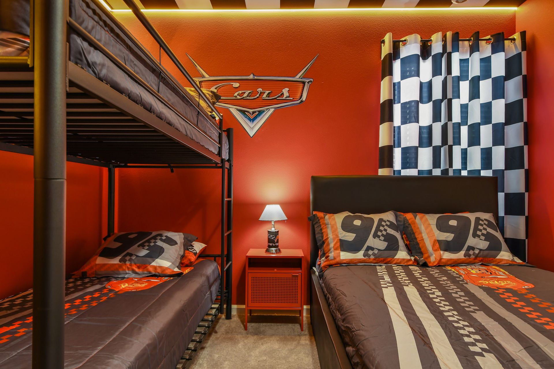 Race into fun with this Cars-themed room featuring bunks, bold colors, and flair.
