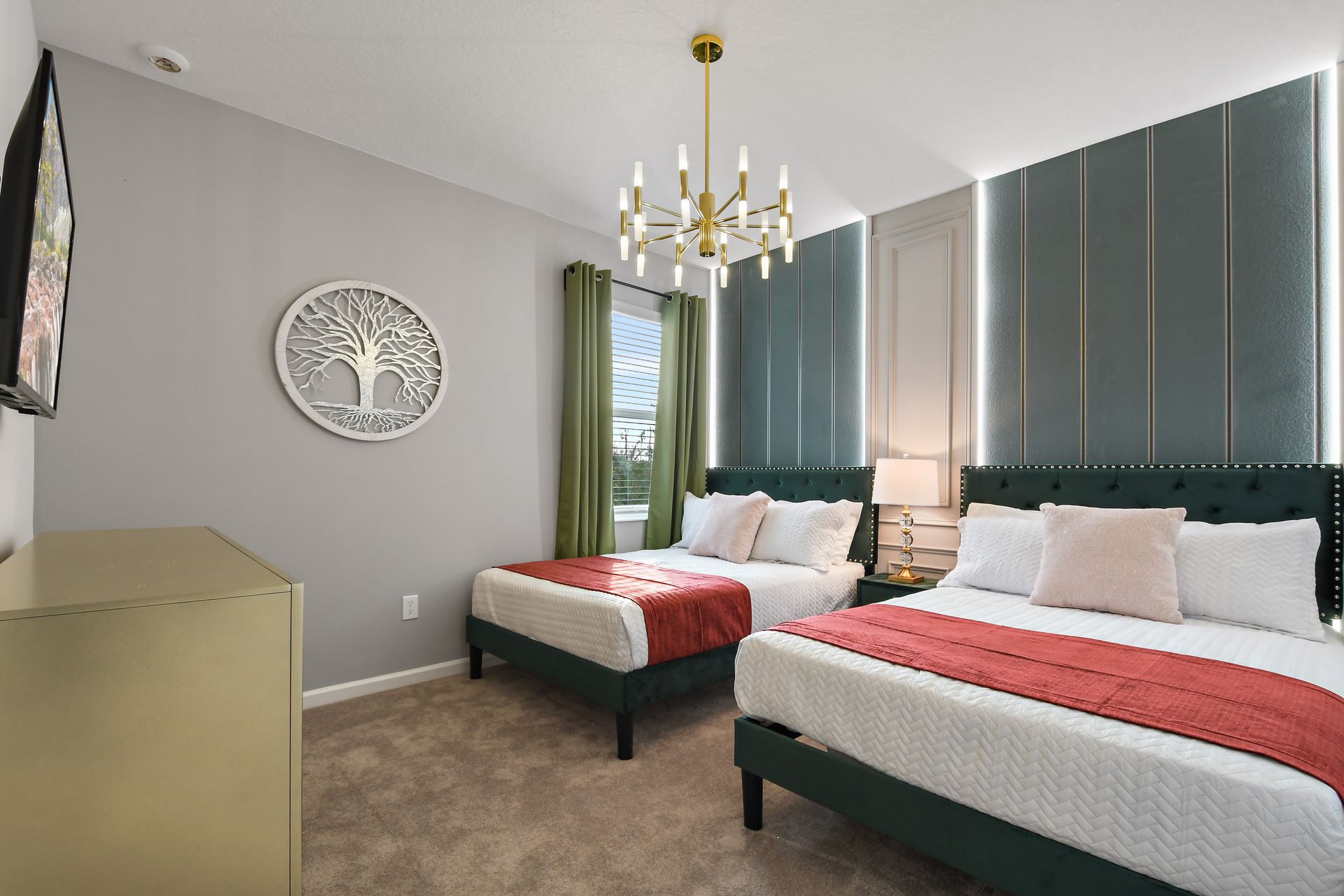 Elegant double bedroom with emerald accents, bold lighting, and cozy beds.

