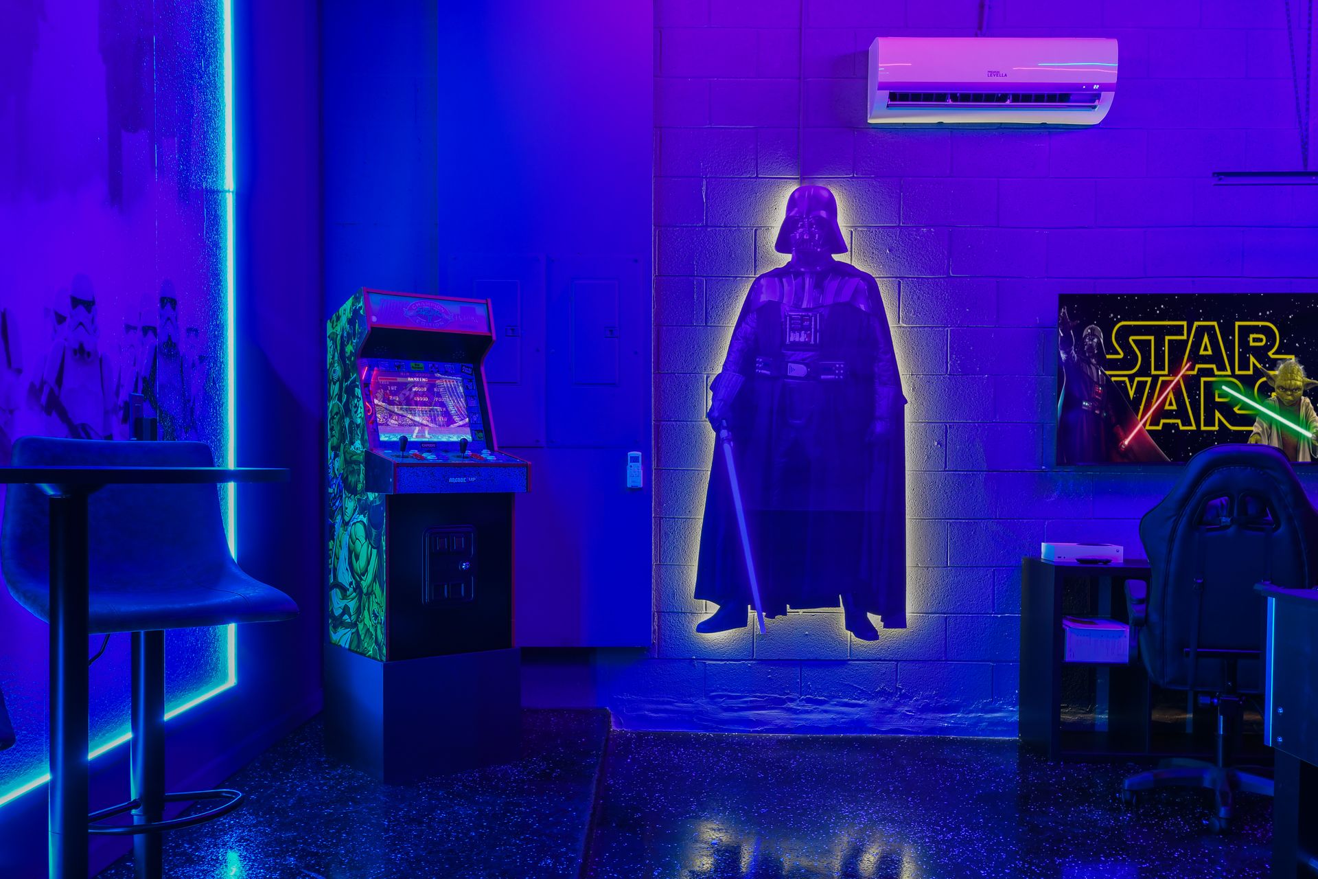 Galactic game room with air hockey, foosball, arcade, and glowing Star Wars decor.
