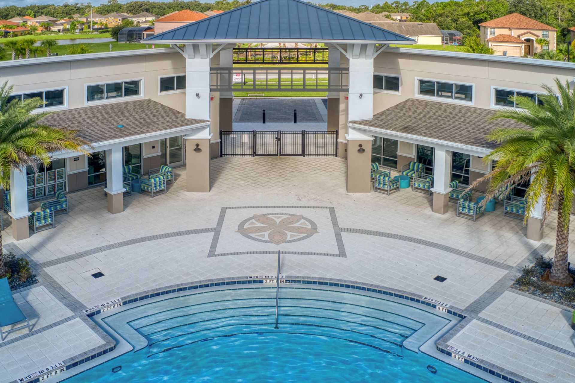 Resort-style retreat with a stunning pool, lush palms, and modern luxury!