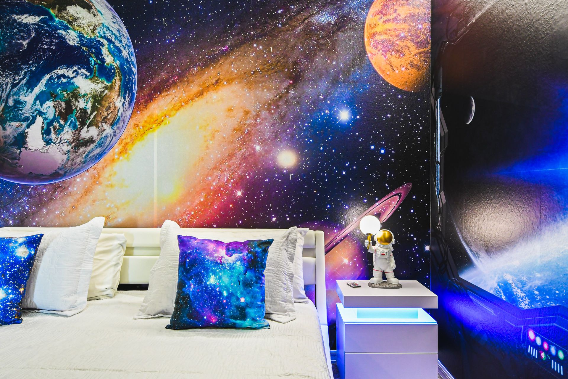 Sleep under the stars in this space-themed bedroom with cosmic decor and flair.
