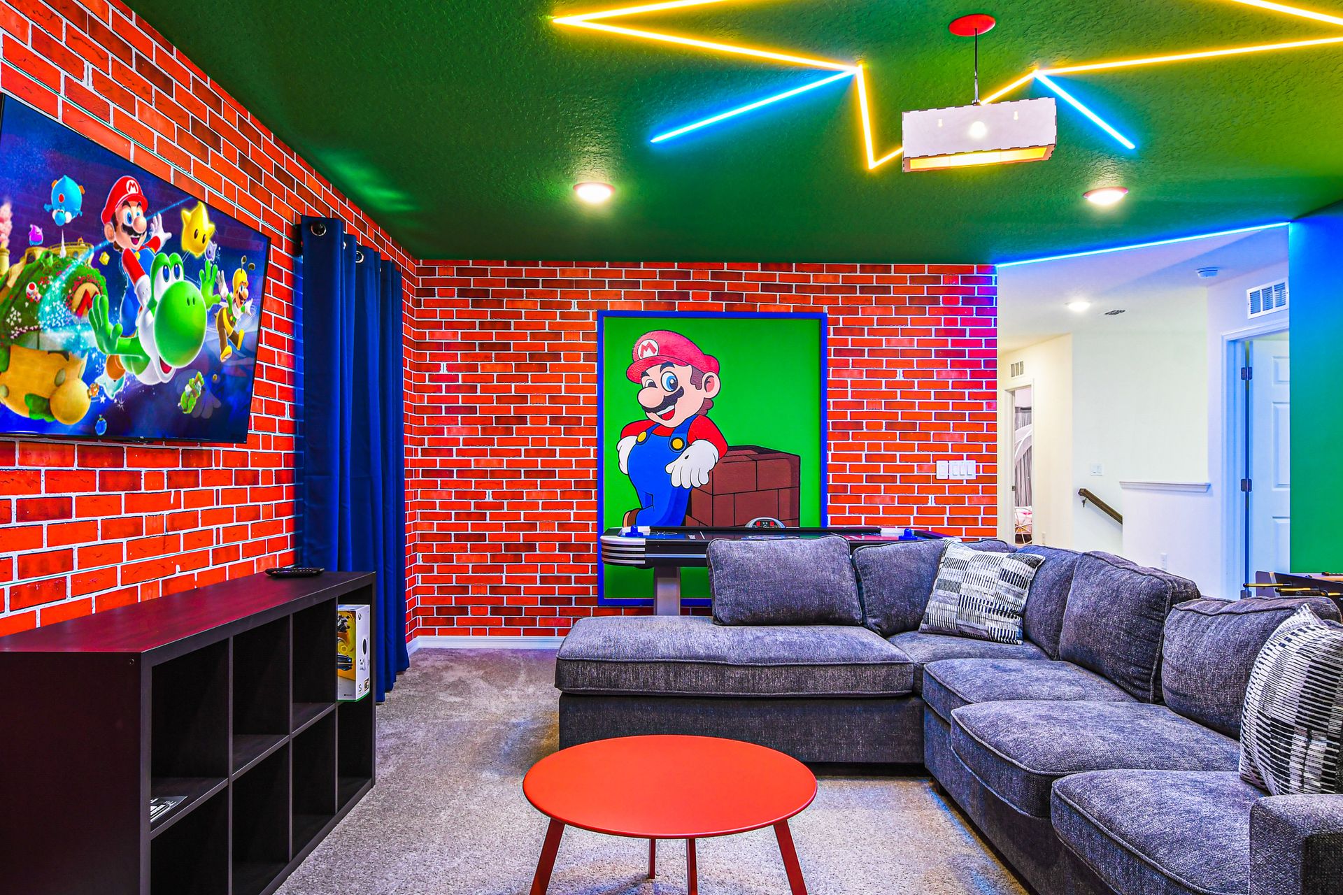 Mario-themed game room with arcade, cozy seating, and vibrant lighting.