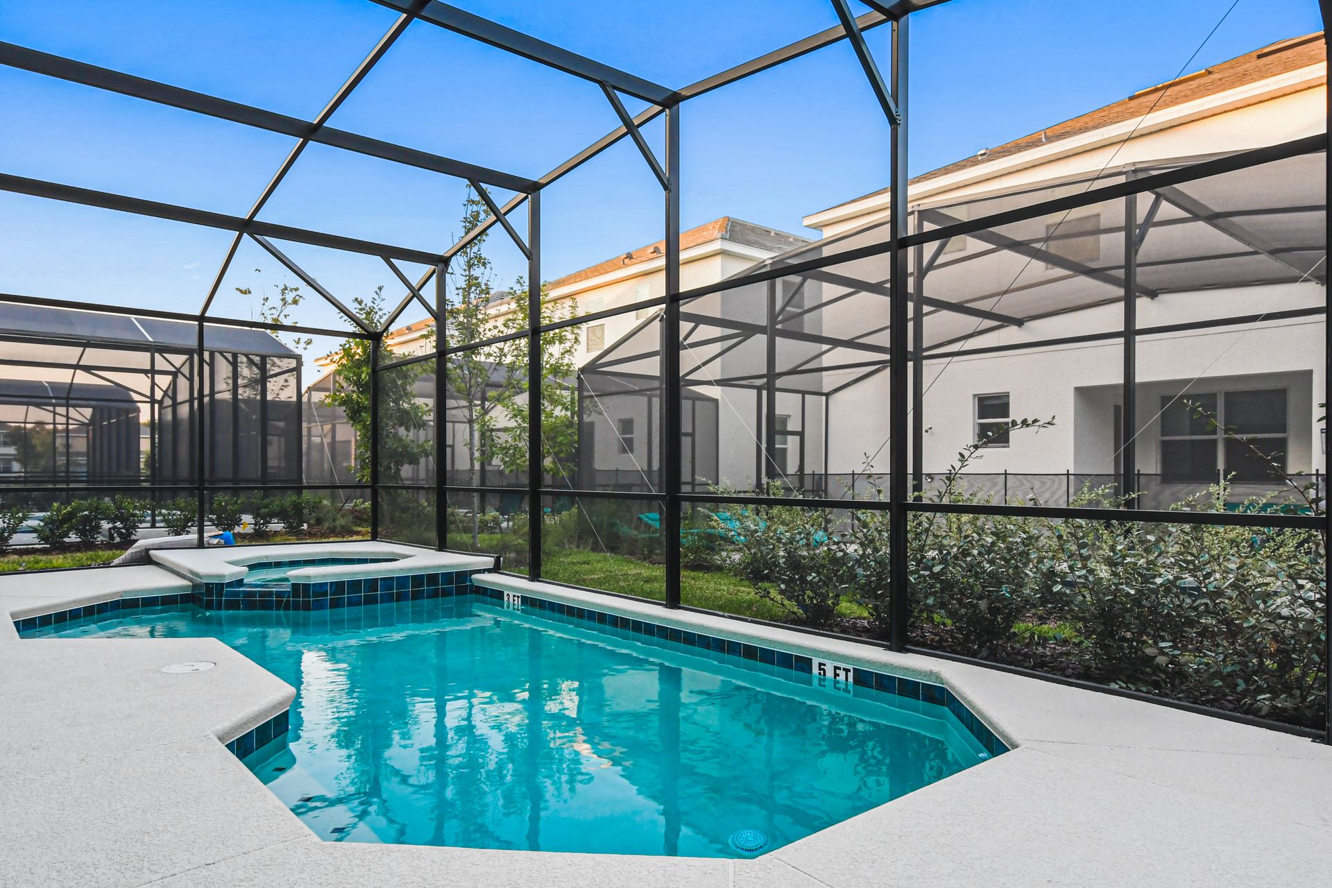 Private screened-in pool and spa with sunny patio, perfect for relaxing or play
