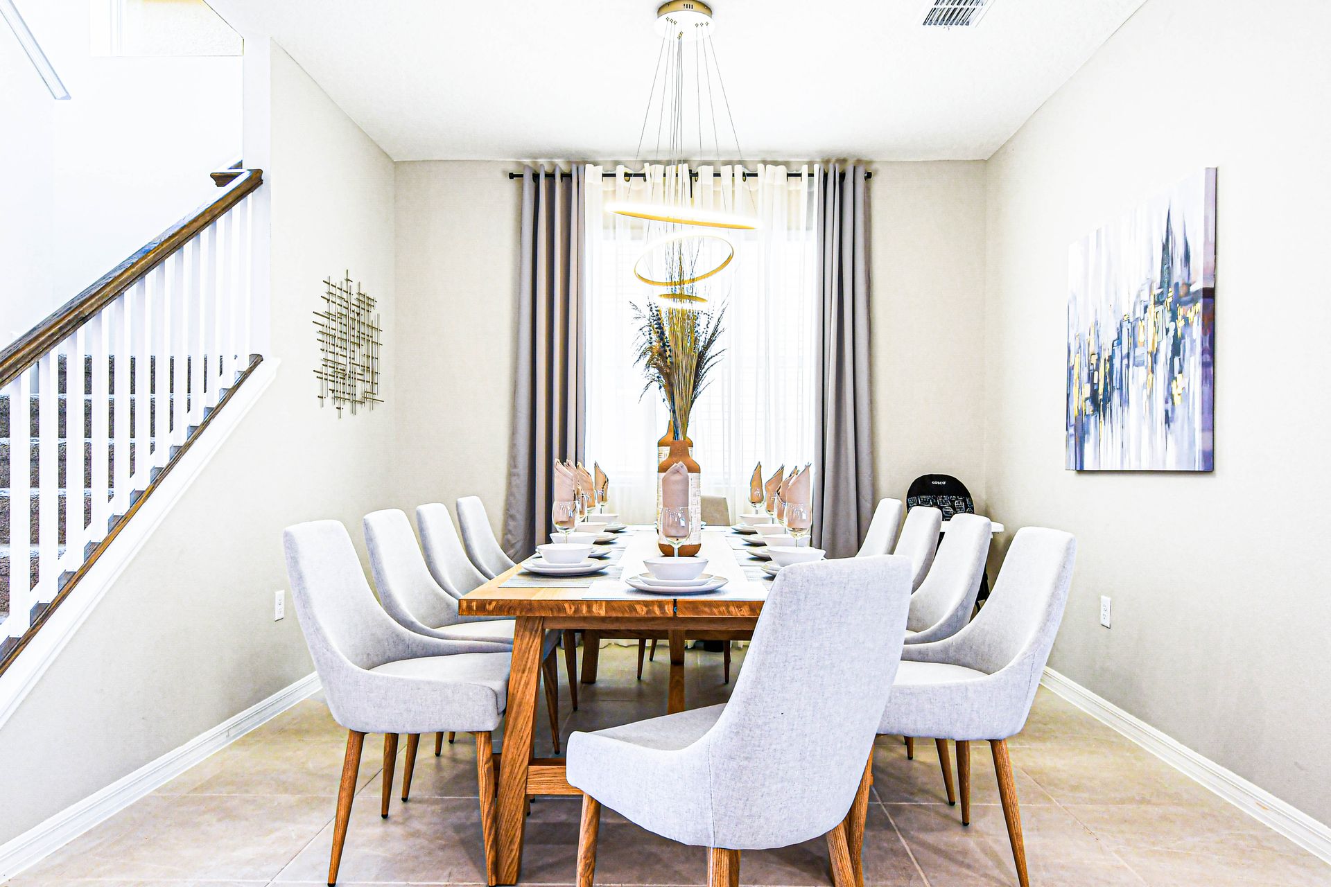 Chic dining room with elegant seating, modern lighting, and natural light.