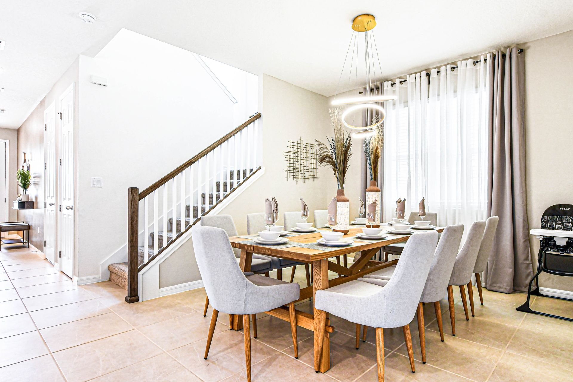 Chic dining room with elegant seating, modern lighting, and natural light.
