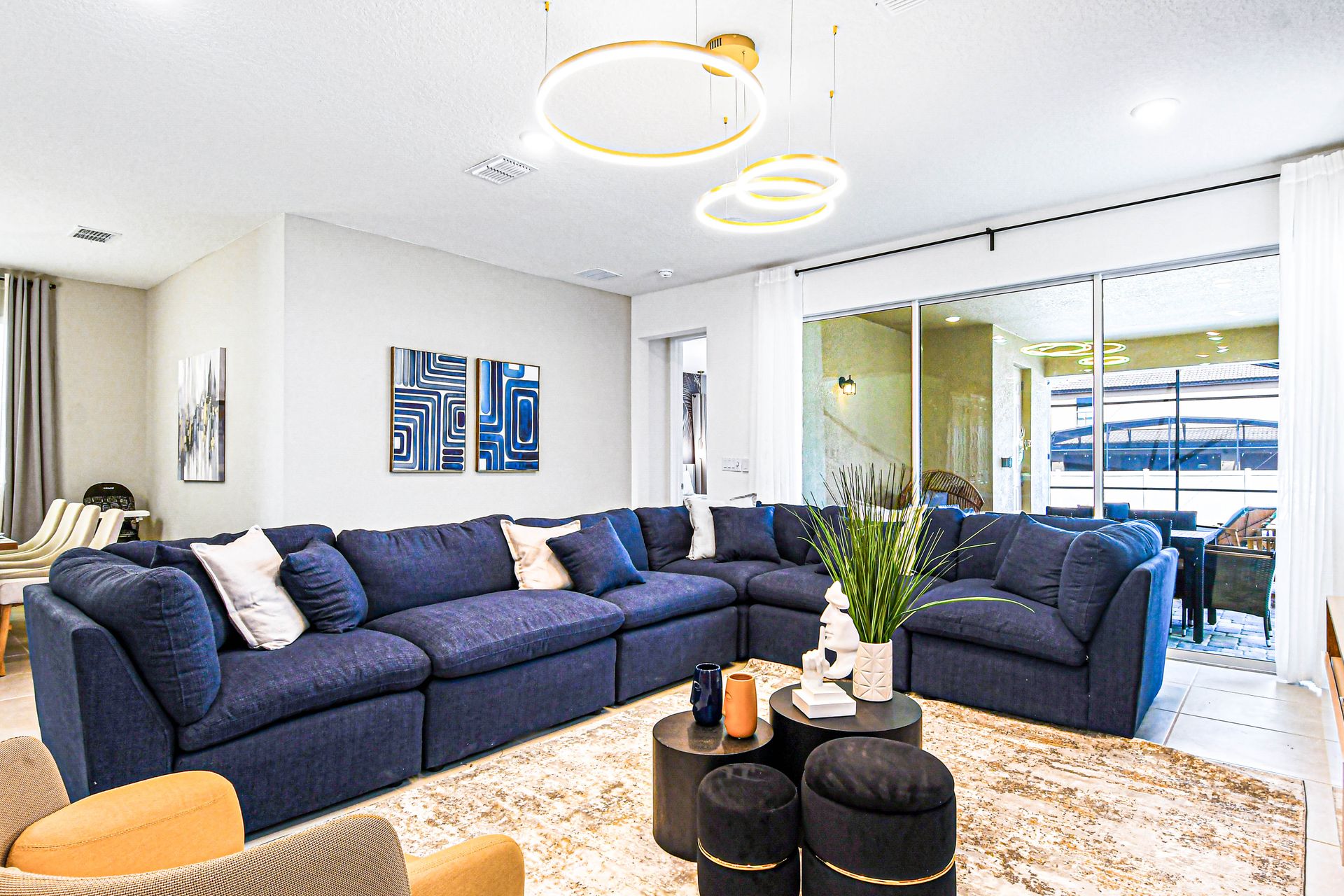 Spacious living room with plush seating, modern decor, and patio access.