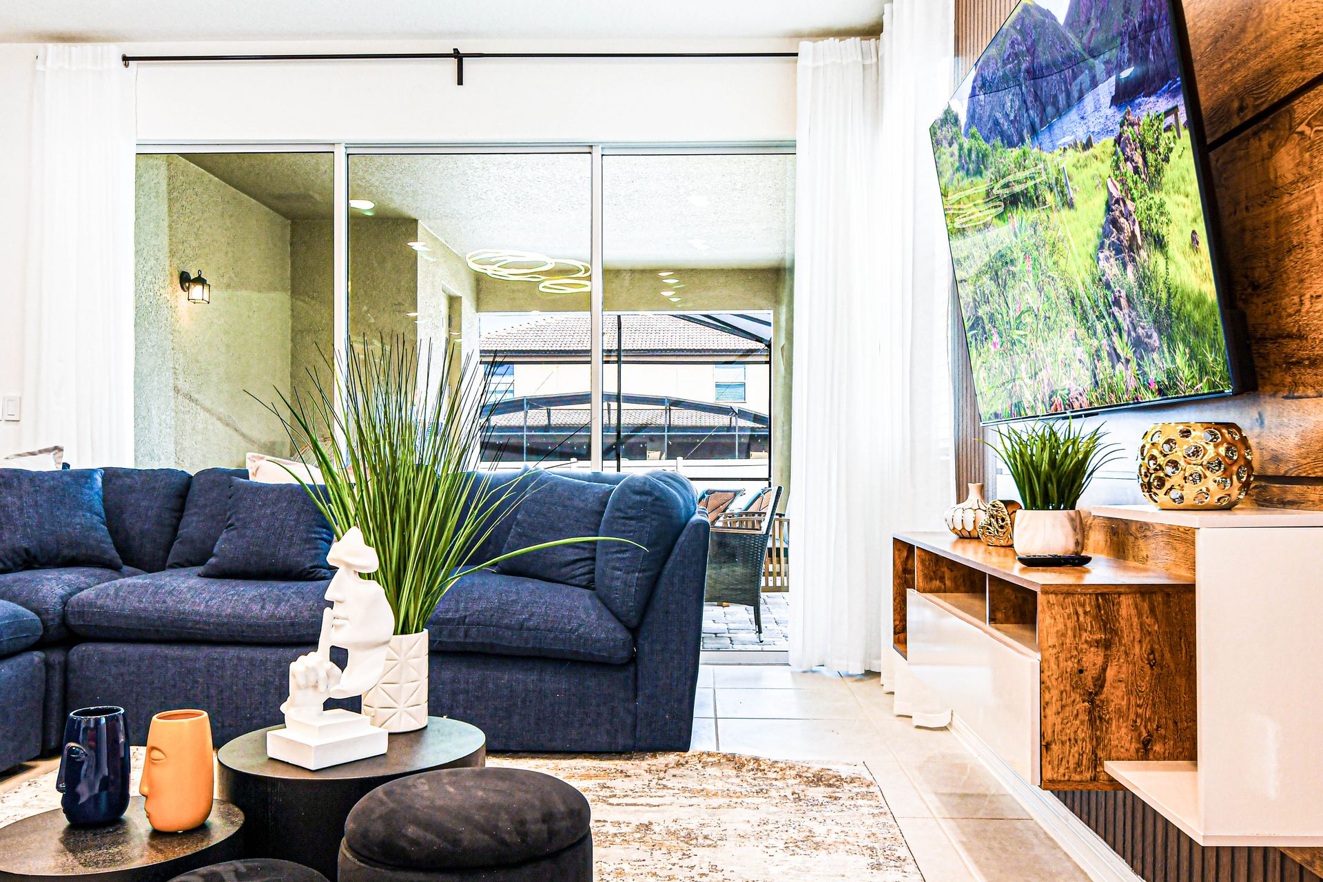 Spacious living room with plush seating, modern decor, and patio access.