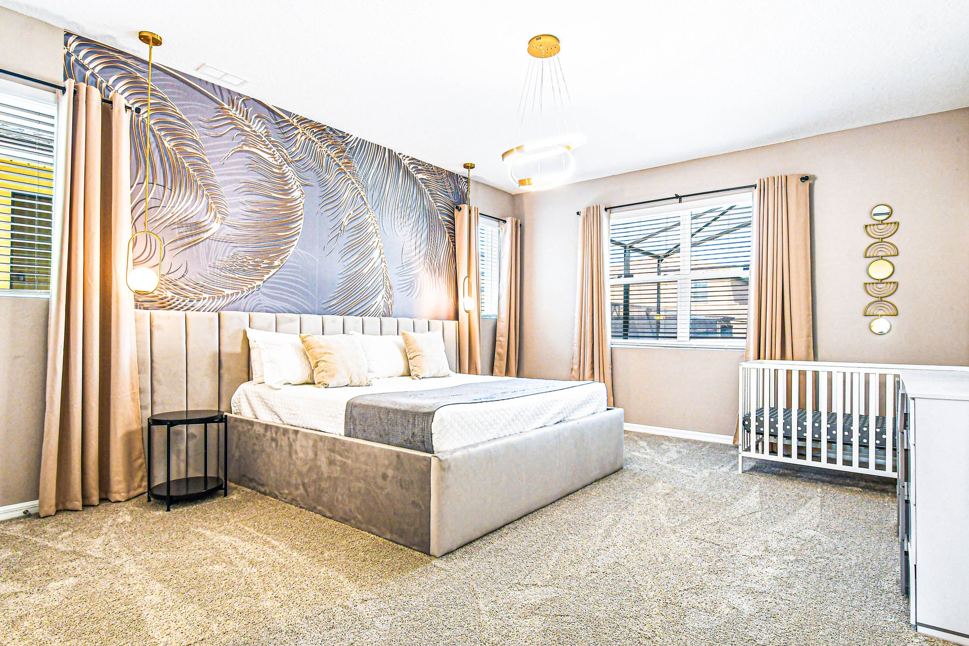 Luxurious bedroom with elegant decor, crib, soft lighting, and modern accents.