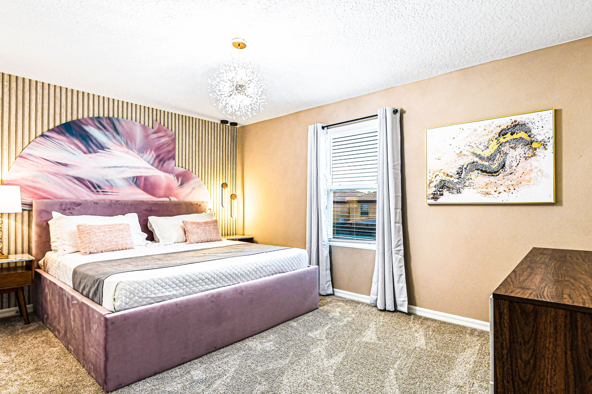 Chic bedroom with soft tones, modern art, and cozy lighting for a restful stay.