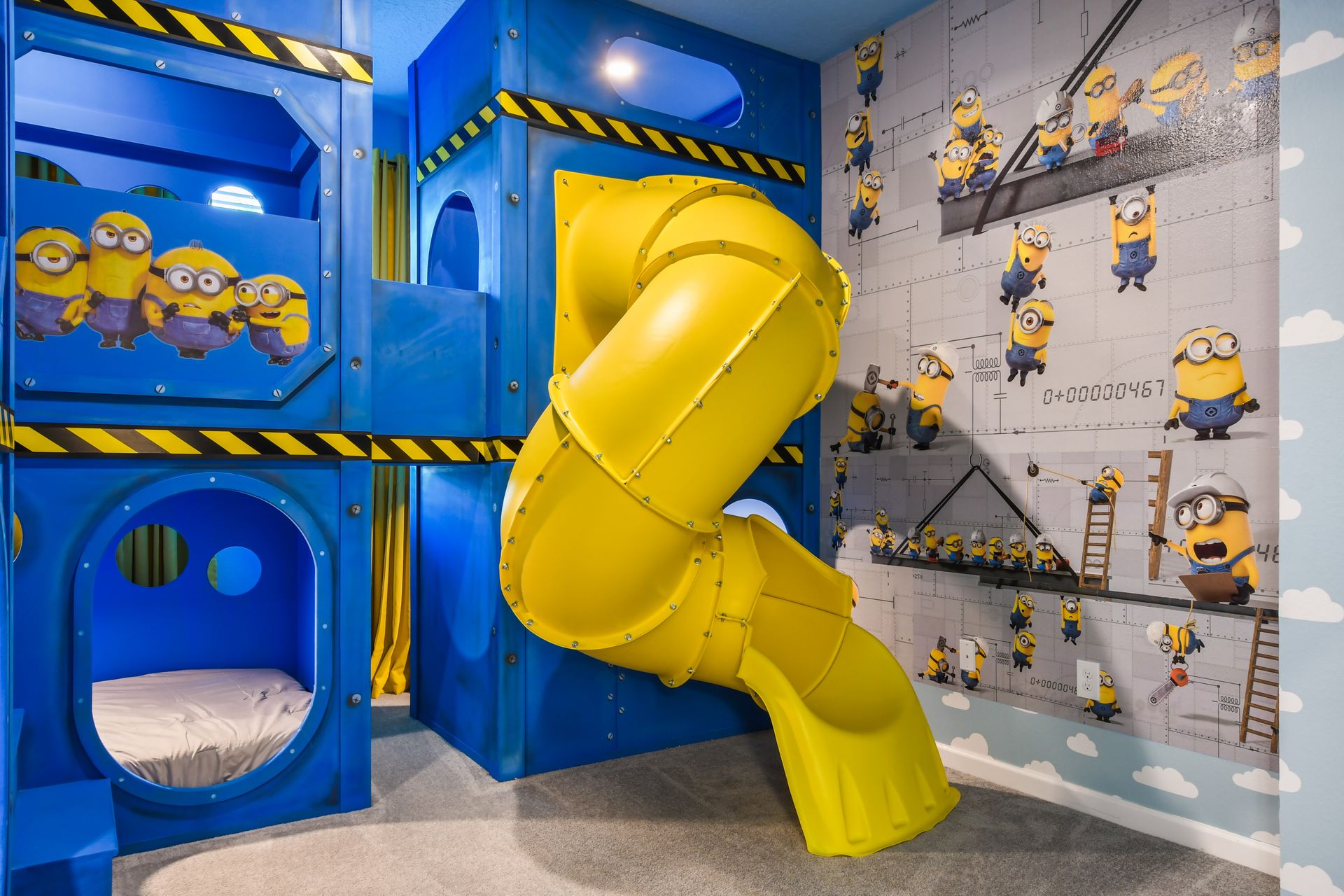 Minion-themed room with slide, bunk beds, and playful decor for family fun.