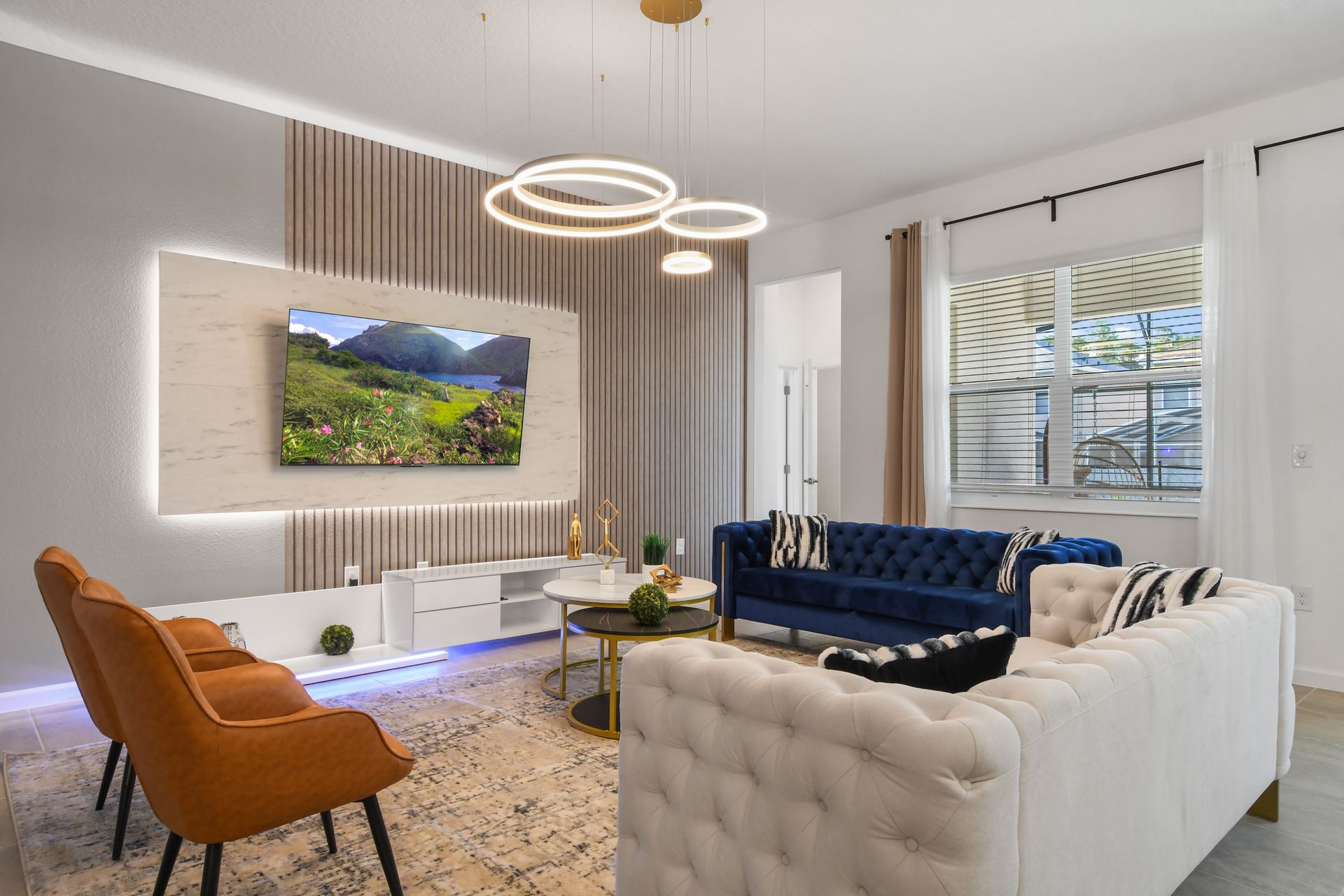 Modern living room with elegant lighting, plush seating, and stylish decor.