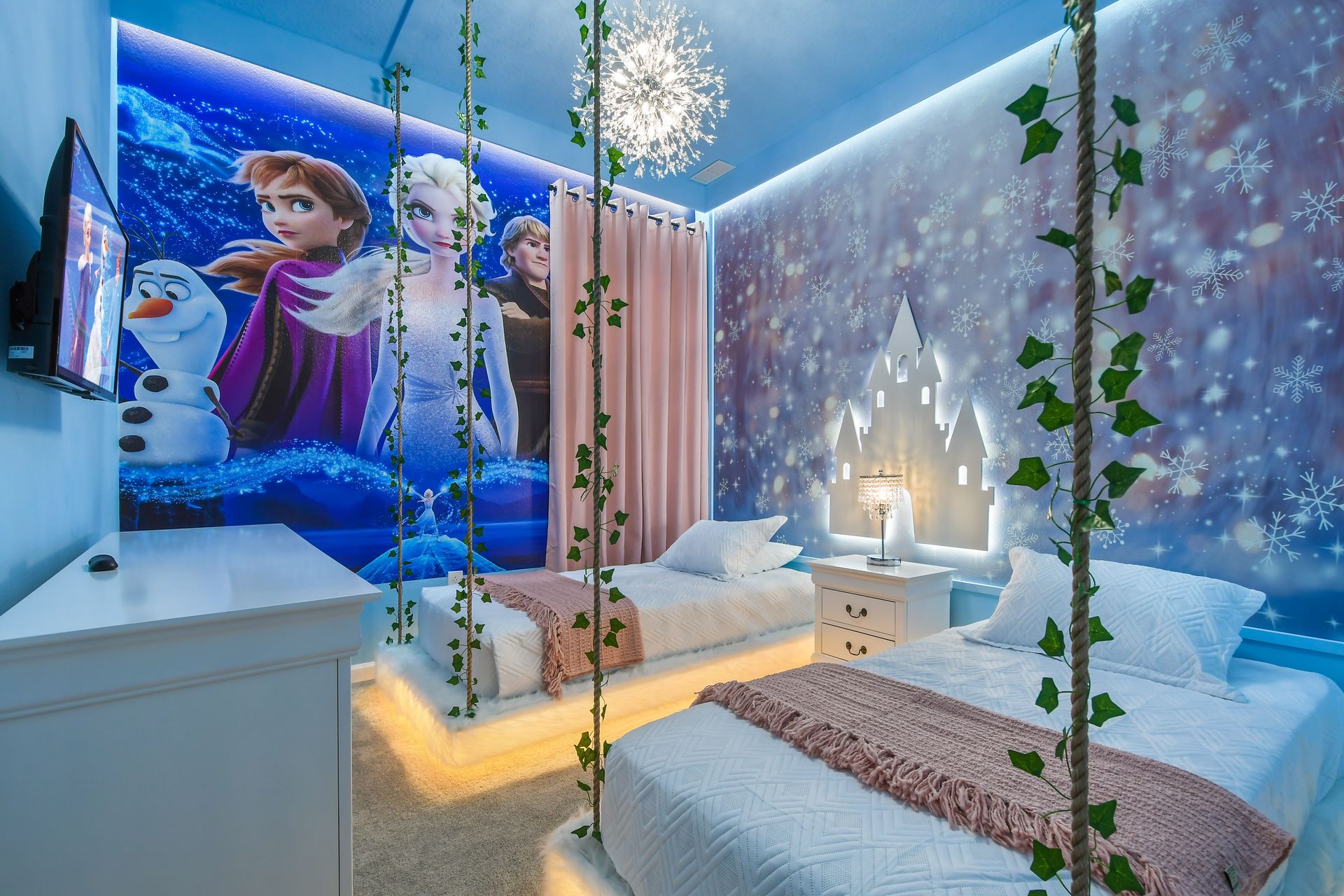 Fairy-tale themed room with snowflake decor, cozy beds, and soft lighting.
