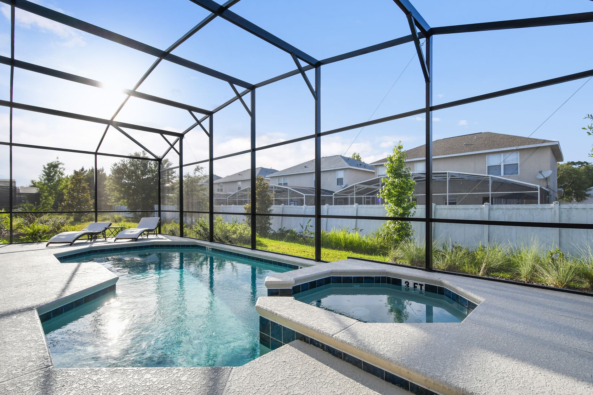 Private screened pool and spa with lounge chairs and sunny garden views.