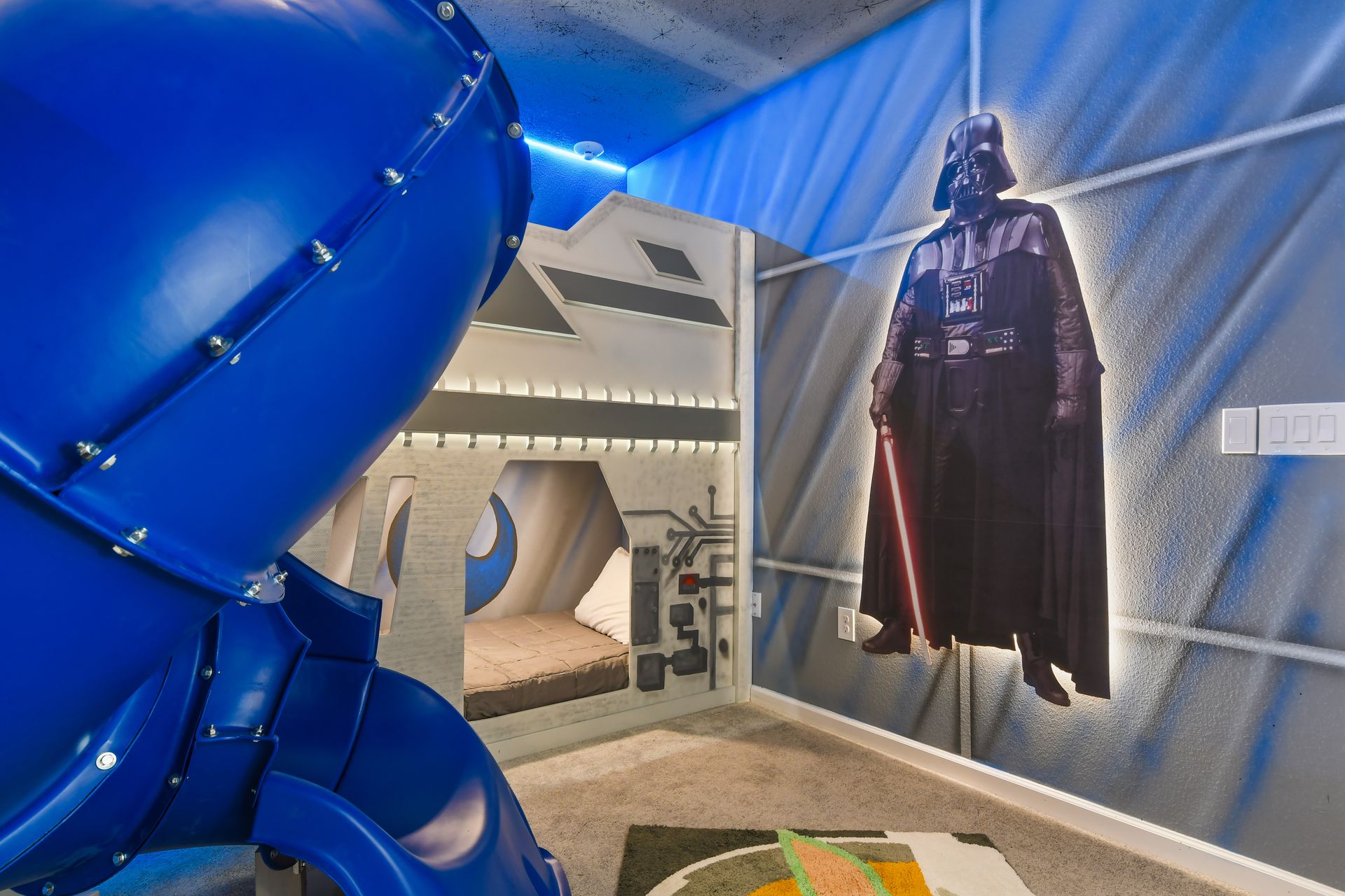 Galaxy-themed room with slide, bunk beds, and iconic decor for epic adventures.