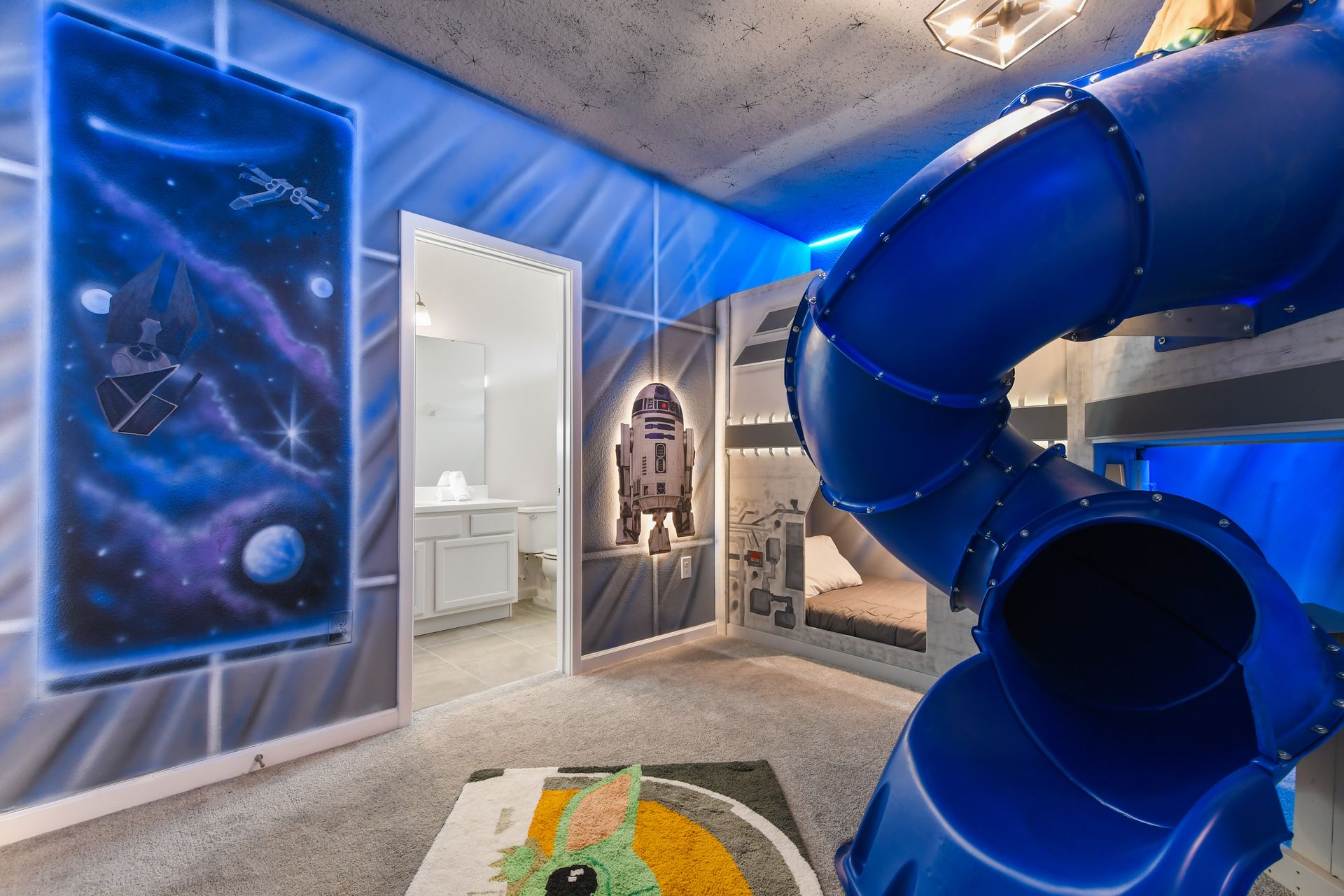 Galaxy-themed room with slide, bunk beds, and iconic decor for epic adventures.